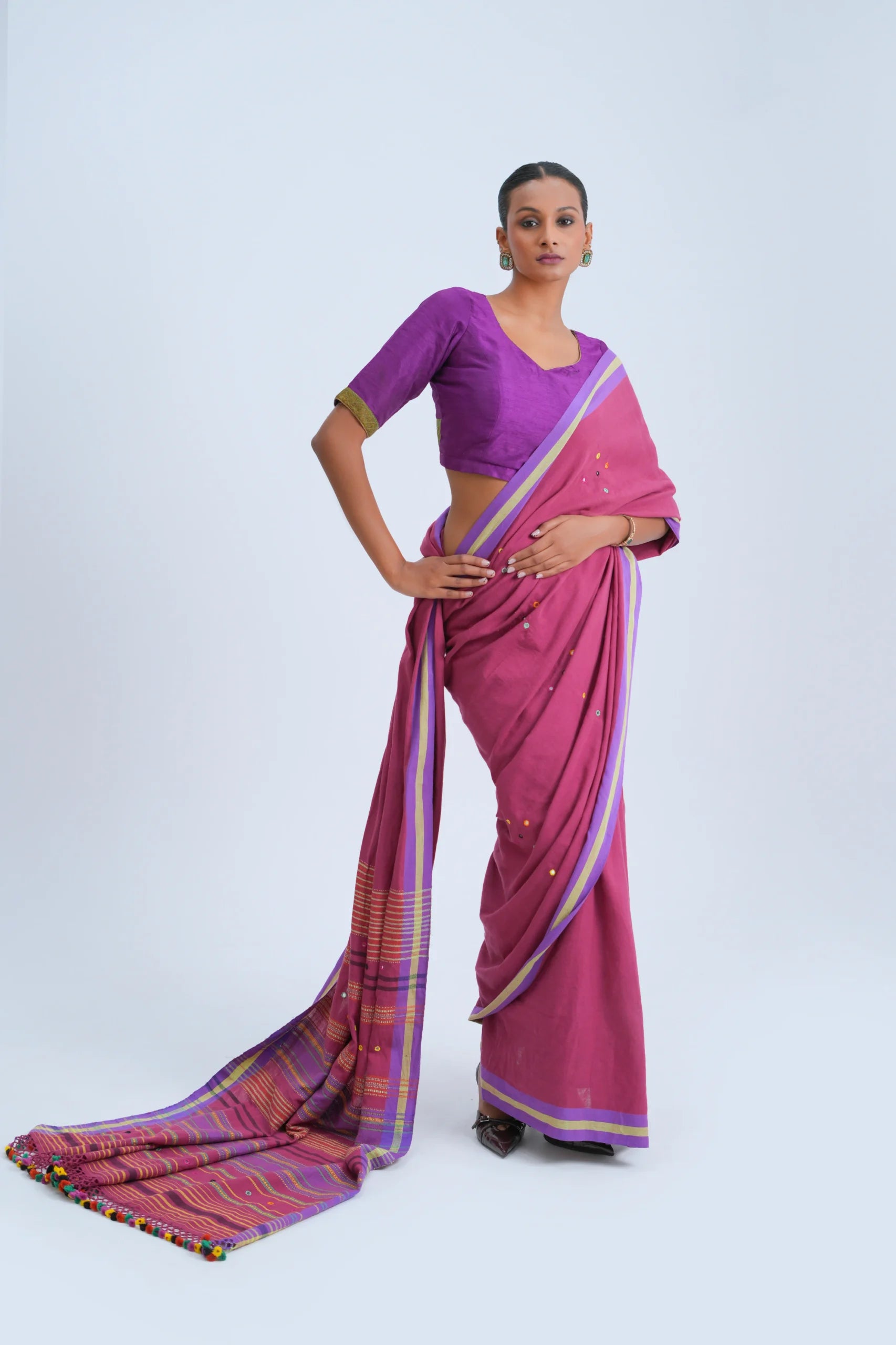 Full-length studio view of a model wearing the deep magenta organic Kala cotton Bhujodi saree featuring lavender-purple borders and a multicolour stripe pallu
