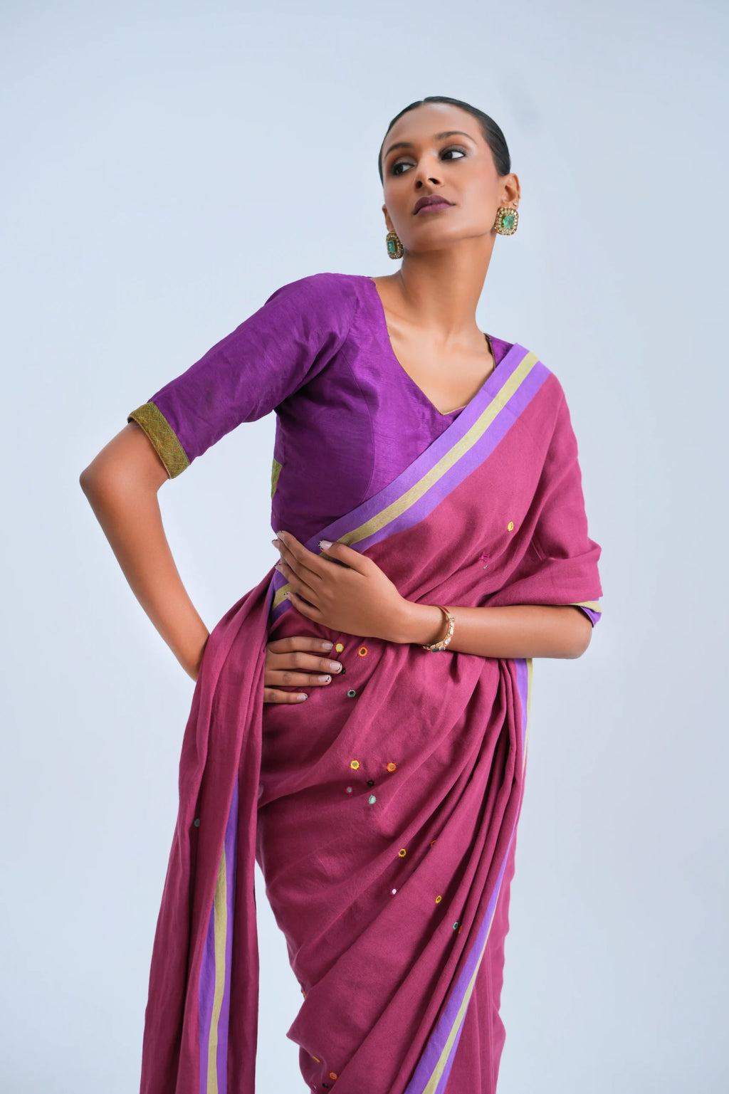Close-up upper body view highlighting the matching purple blouse piece, mirror work embellishments, and clean border alignment