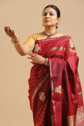 
Maroon Veldhari Kanchipuram handloom silk saree featuring traditional elephant motifs and real gold zari displayed by a model