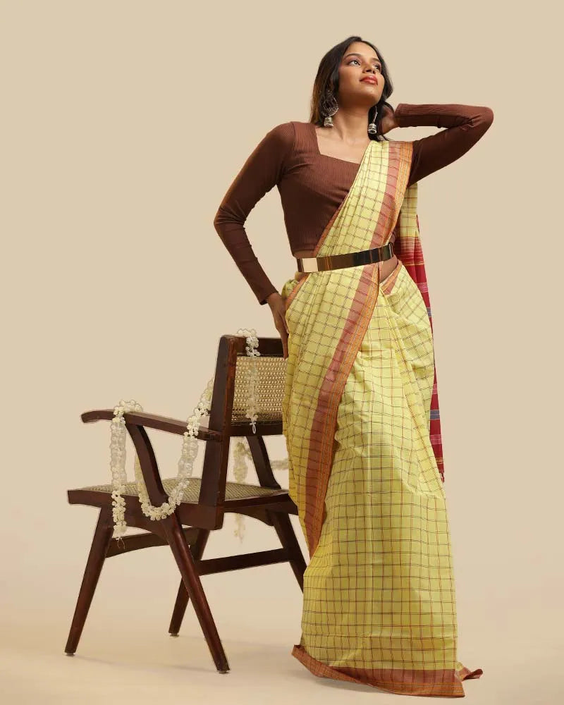 Standing full-length studio shot highlighting the complete length, pleat alignment, and styling of the Kasaragod cotton saree