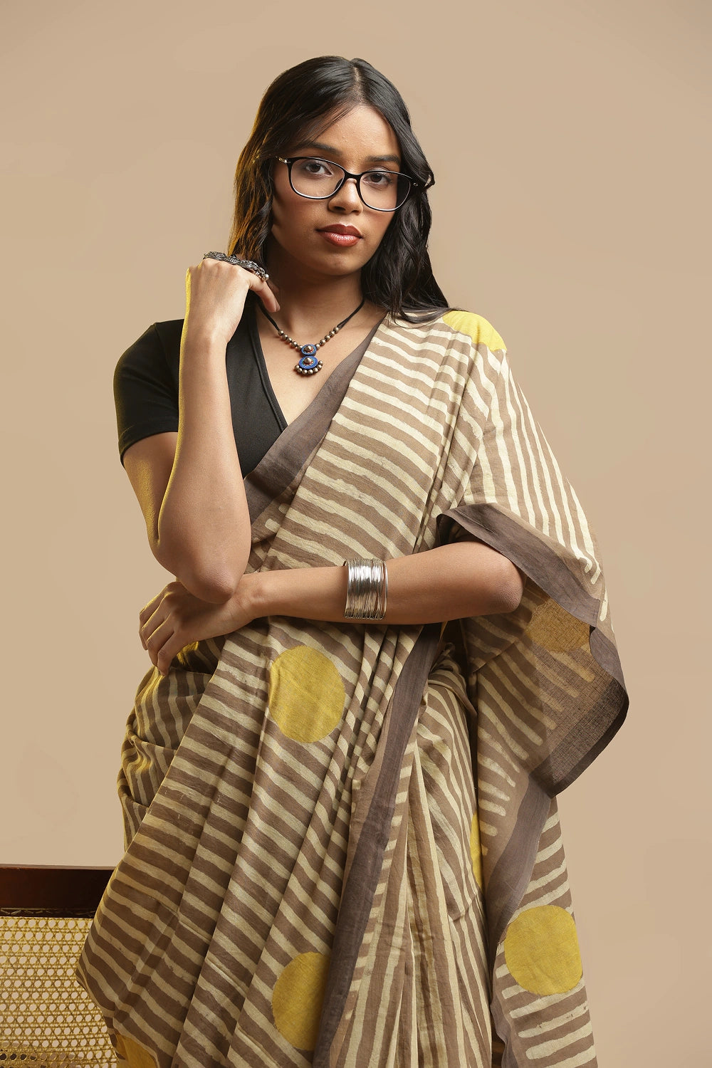 Full length view of the beige Bagru hand-block print cotton saree showing the traditional drape and styling