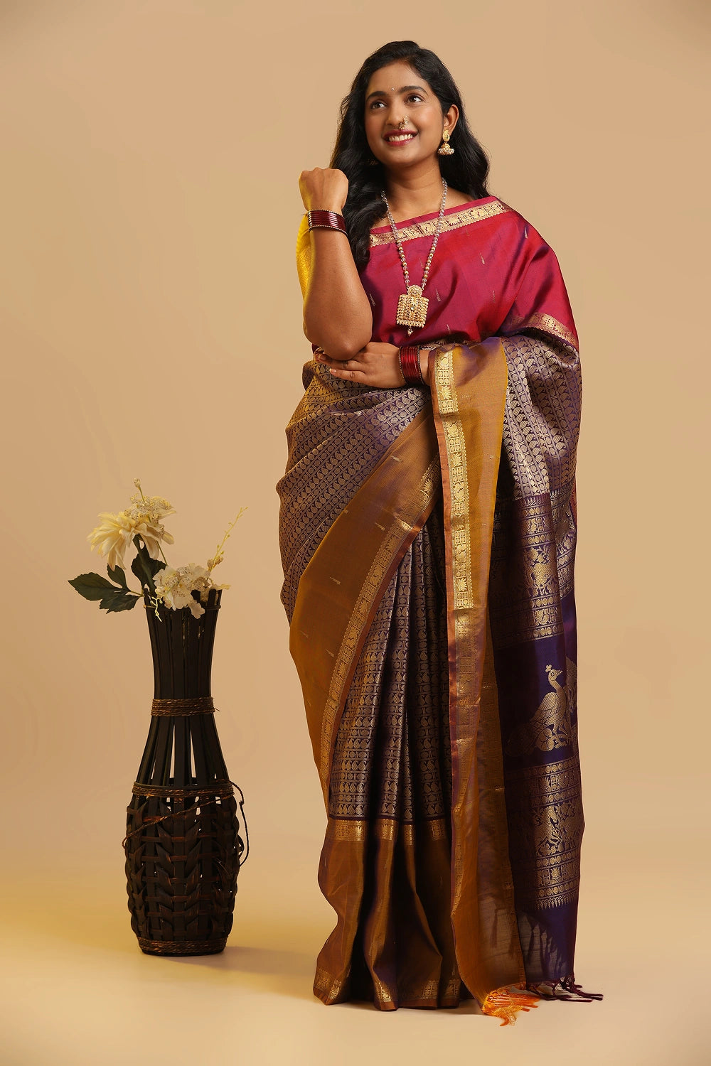 Muppagam Ganga Jamuna Kanchipuram handloom silk saree in maroon and purple with mustard borders displayed by a model