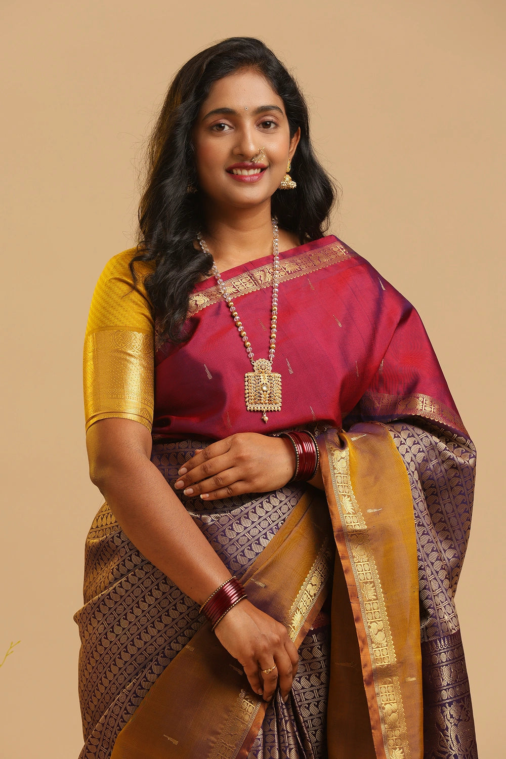 Model showcasing the rich drape and traditional styling of the Muppagam Kanchipuram silk saree