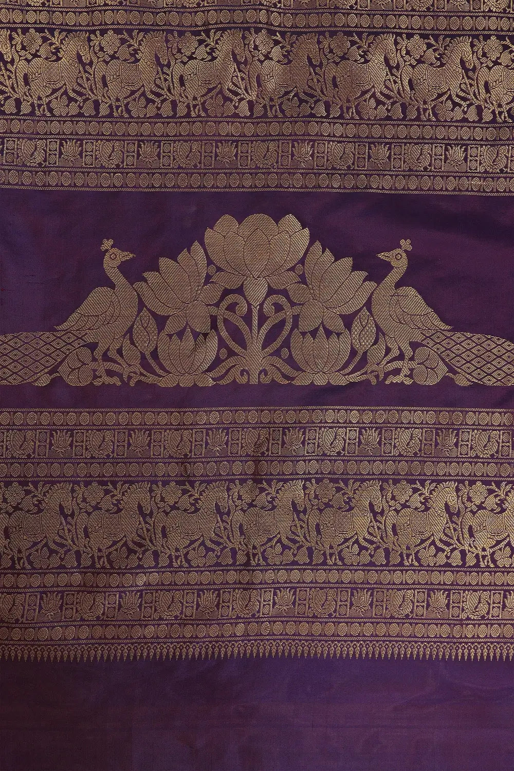 Close-up view showcasing the complex Muppagam three-border weave and real gold zari work