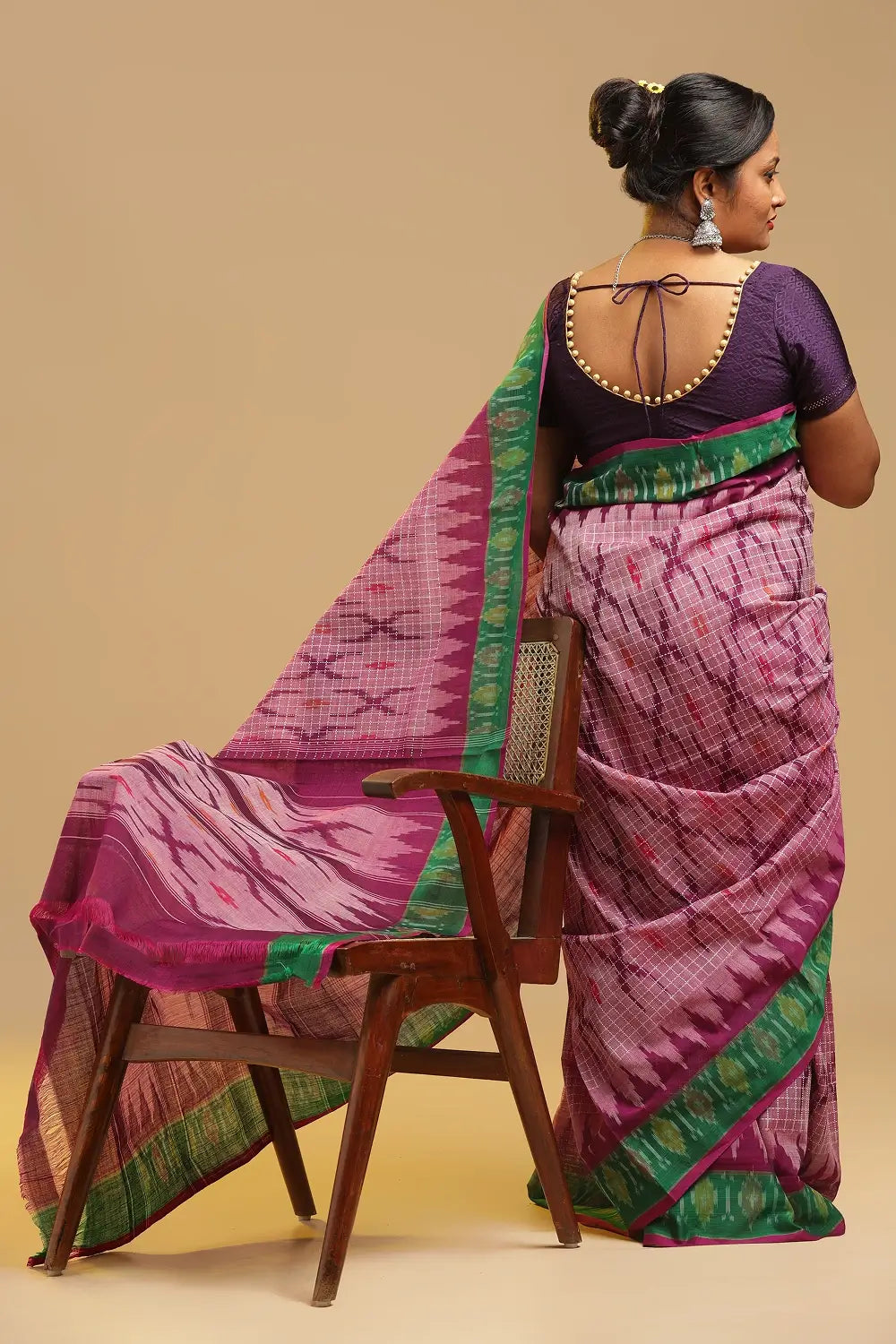 Detail view of the self pallu featuring the pearl-like purple ikat pattern