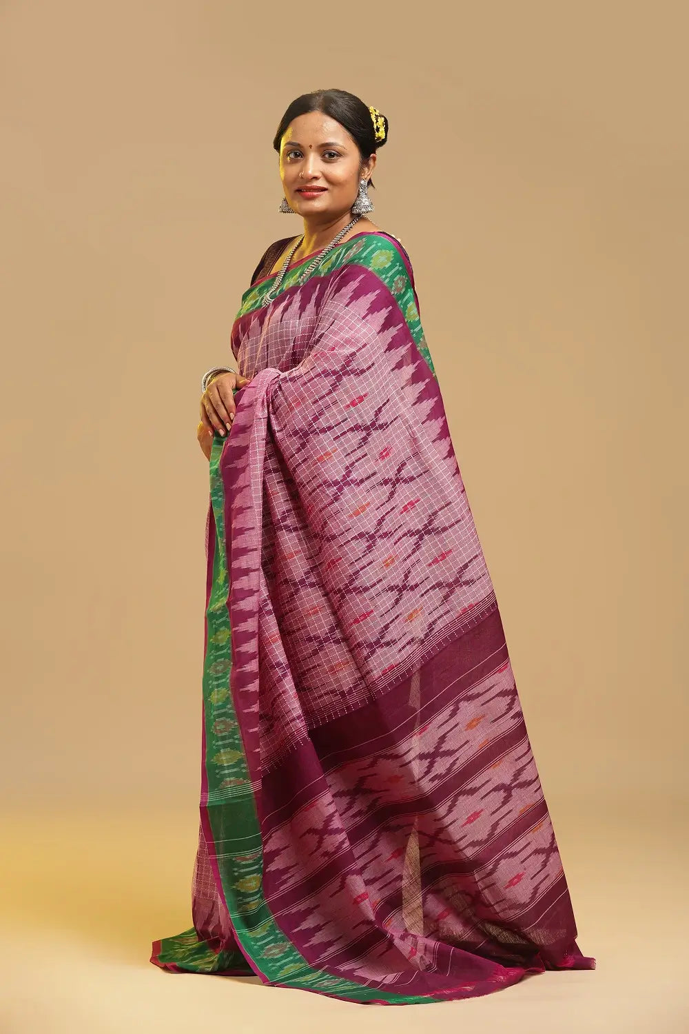 Side profile view of a model wearing the pink Muthyampet check cotton saree