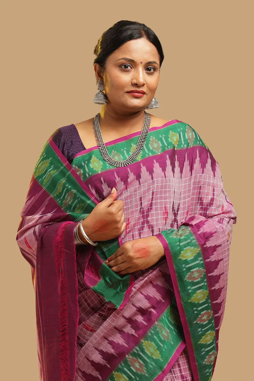 Upper body view highlighting the draped pink Muthyampet check cotton saree and jewelry