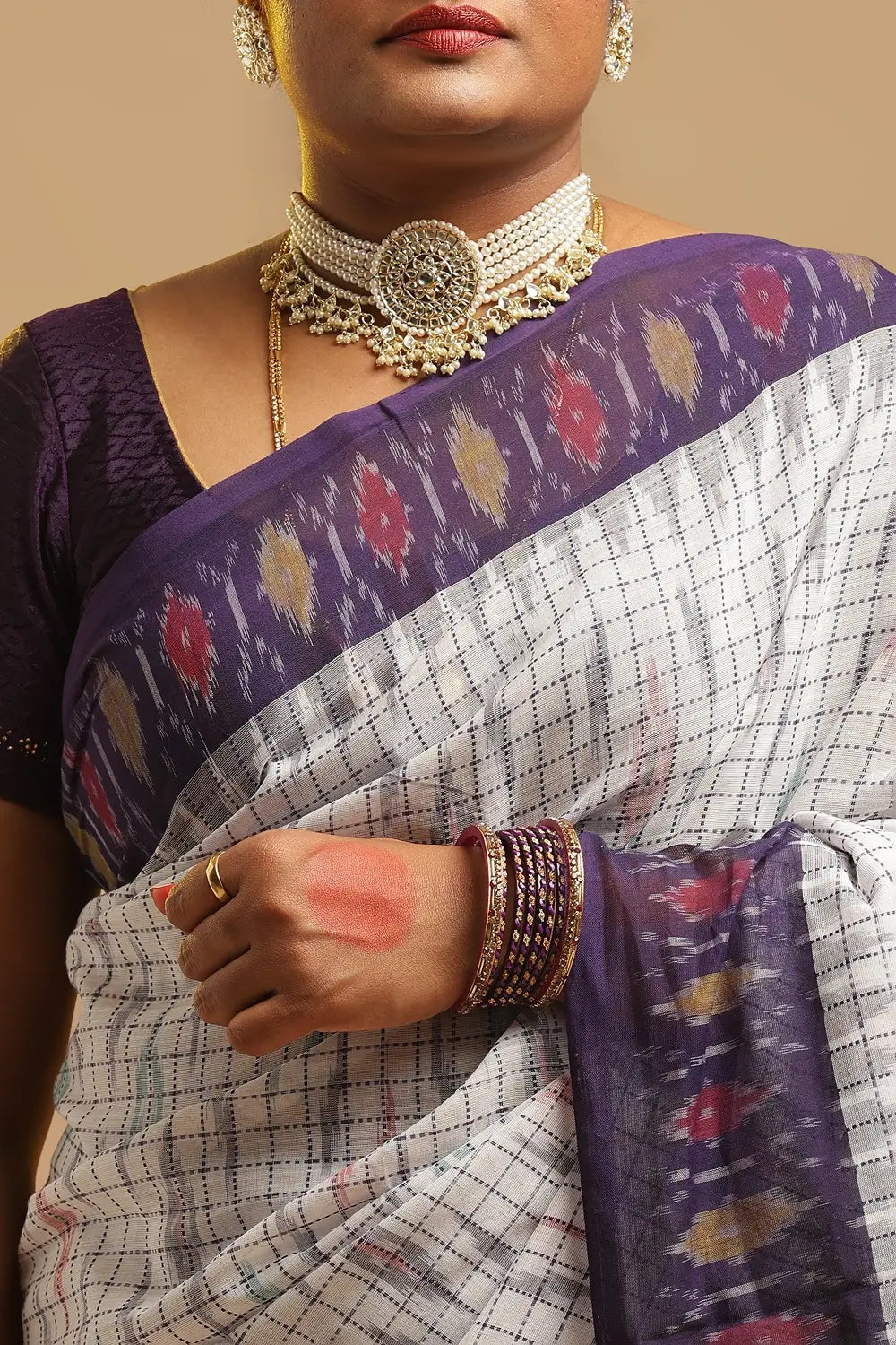 Close-up view of the upper body showcasing the white check weave, silver choker necklace, and midnight blue border