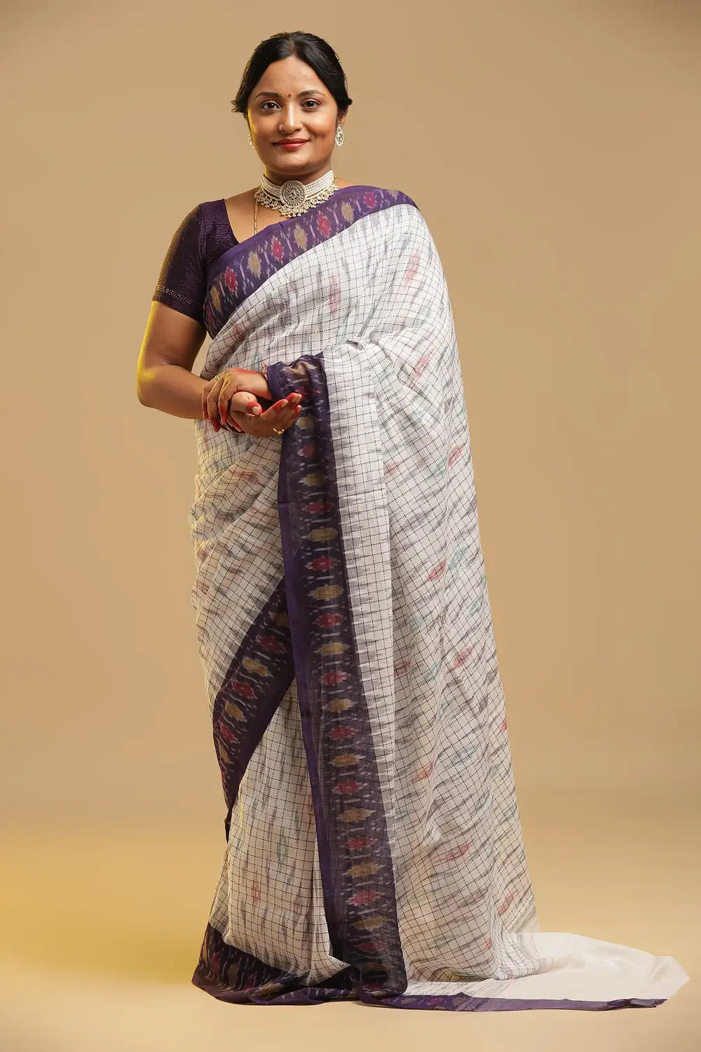 Front view of the model showcasing the full length and drape of the white and purple cotton saree