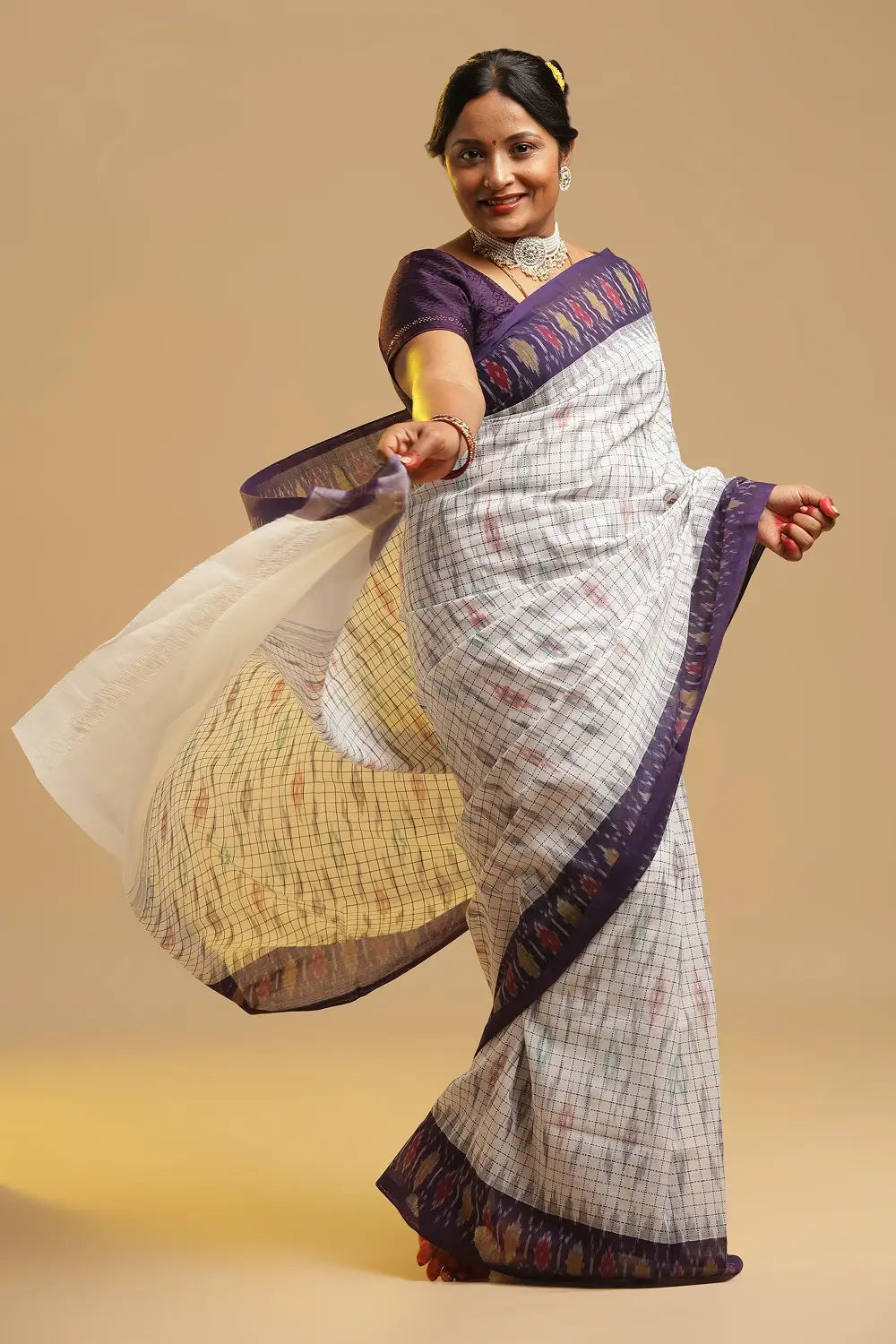 Detail view of the pallu highlighting the grey and red ikat pattern and broad midnight purple panel with yellow and red pearl ikat design