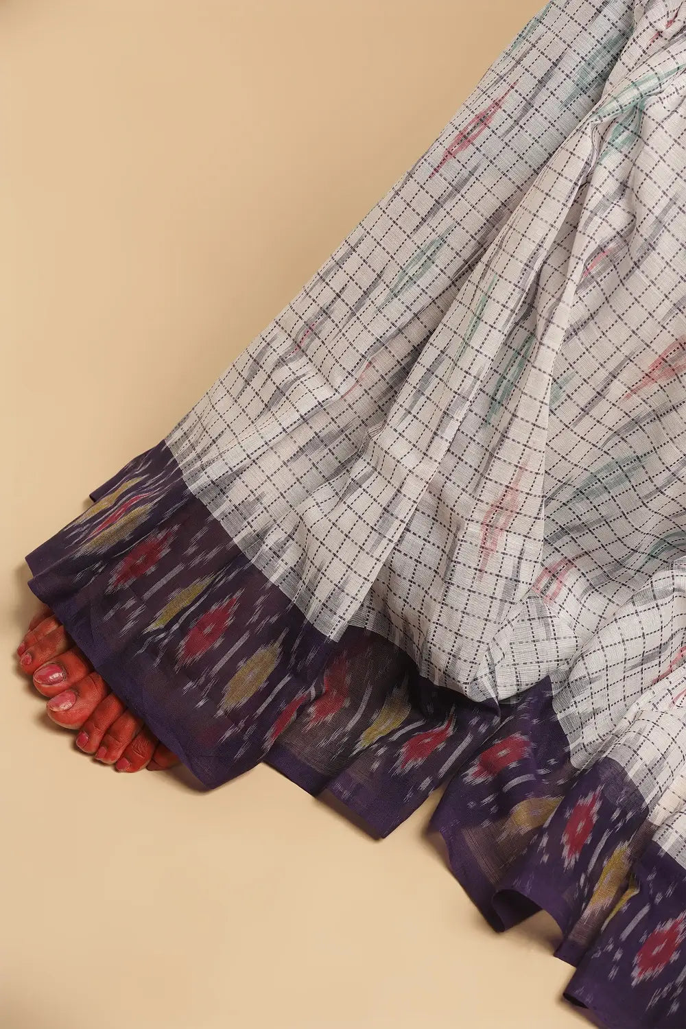 Close-up view of the saree pleats highlighting the texture and border details