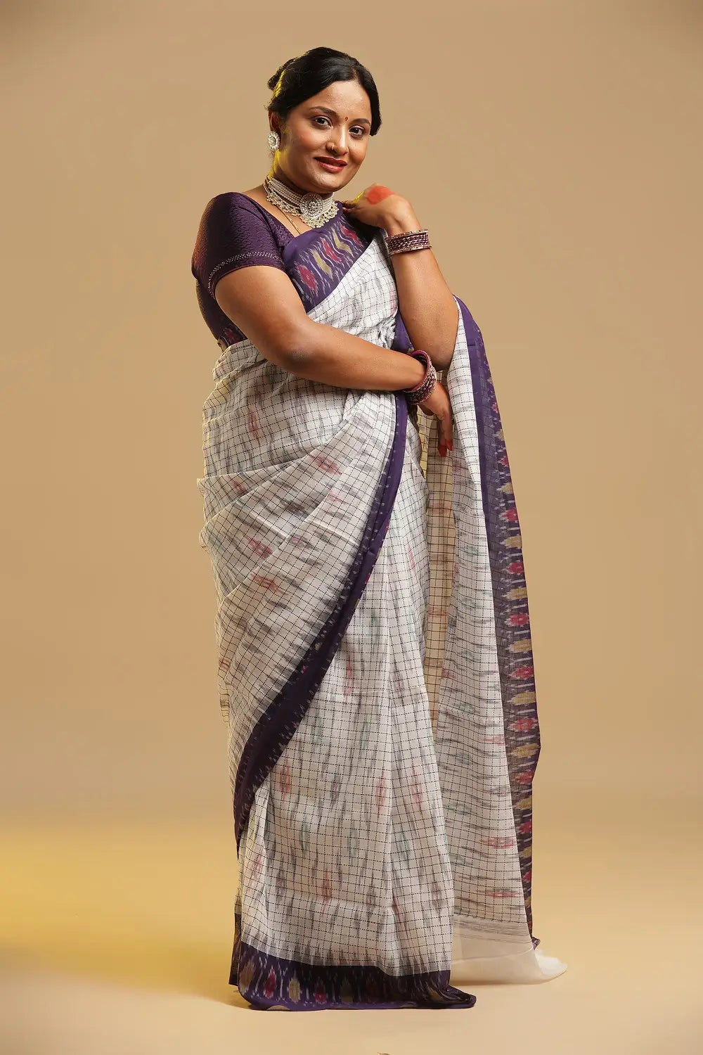 Side profile view of a model wearing the white Muthyampet check cotton saree