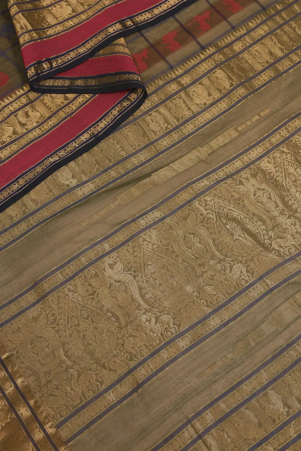 Detailed view of the individually handwoven wildlife motifs across the pure cotton saree body