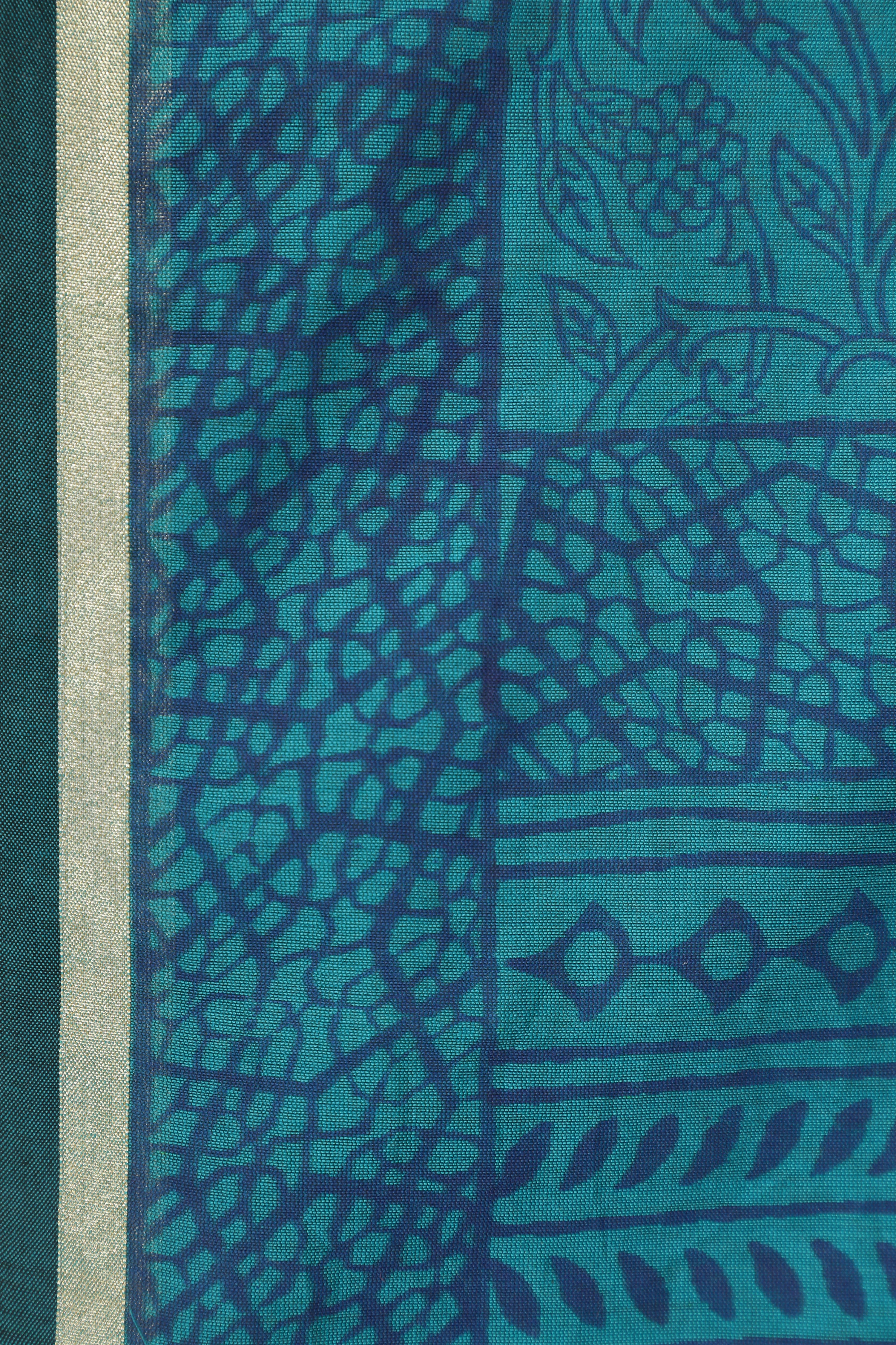Macro close-up of the mercerized cotton-silk fabric highlighting the fine weave structure, delicate handblock print lines, and shimmering border edge