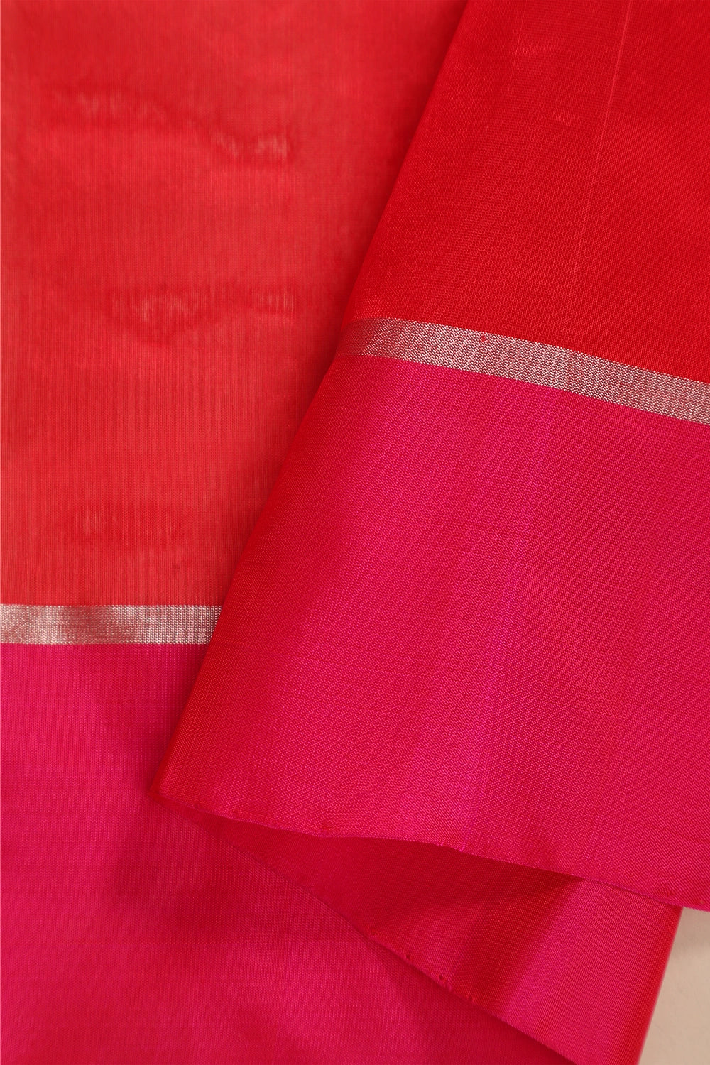 Flat-lay studio arrangement showcasing the intricate patela resham pink border and subtle zari lines of the Chanderi pattu silk saree