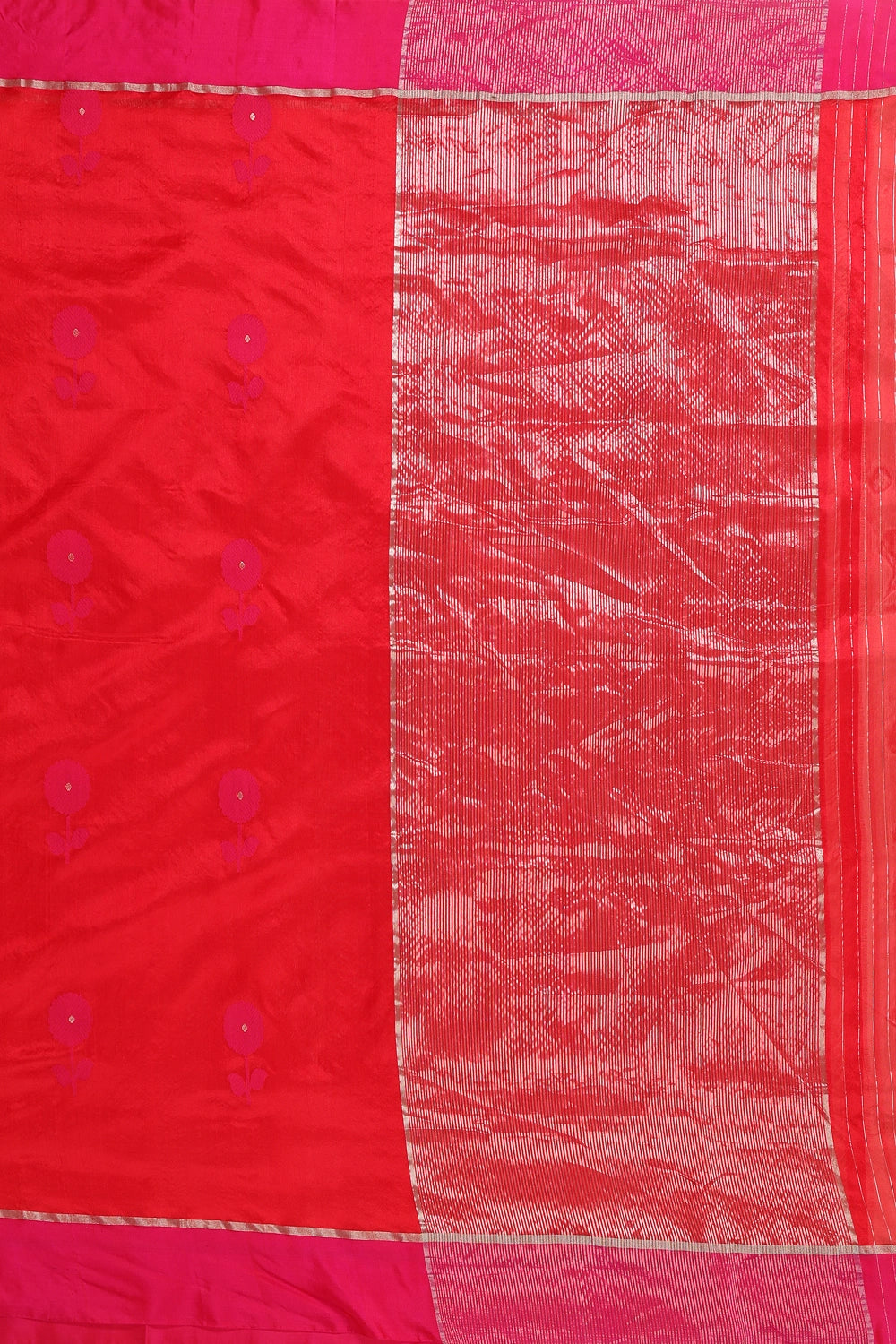 Flat-lay studio arrangement highlighting the detailed floral motifs and pink border weave of the Chanderi pattu silk saree