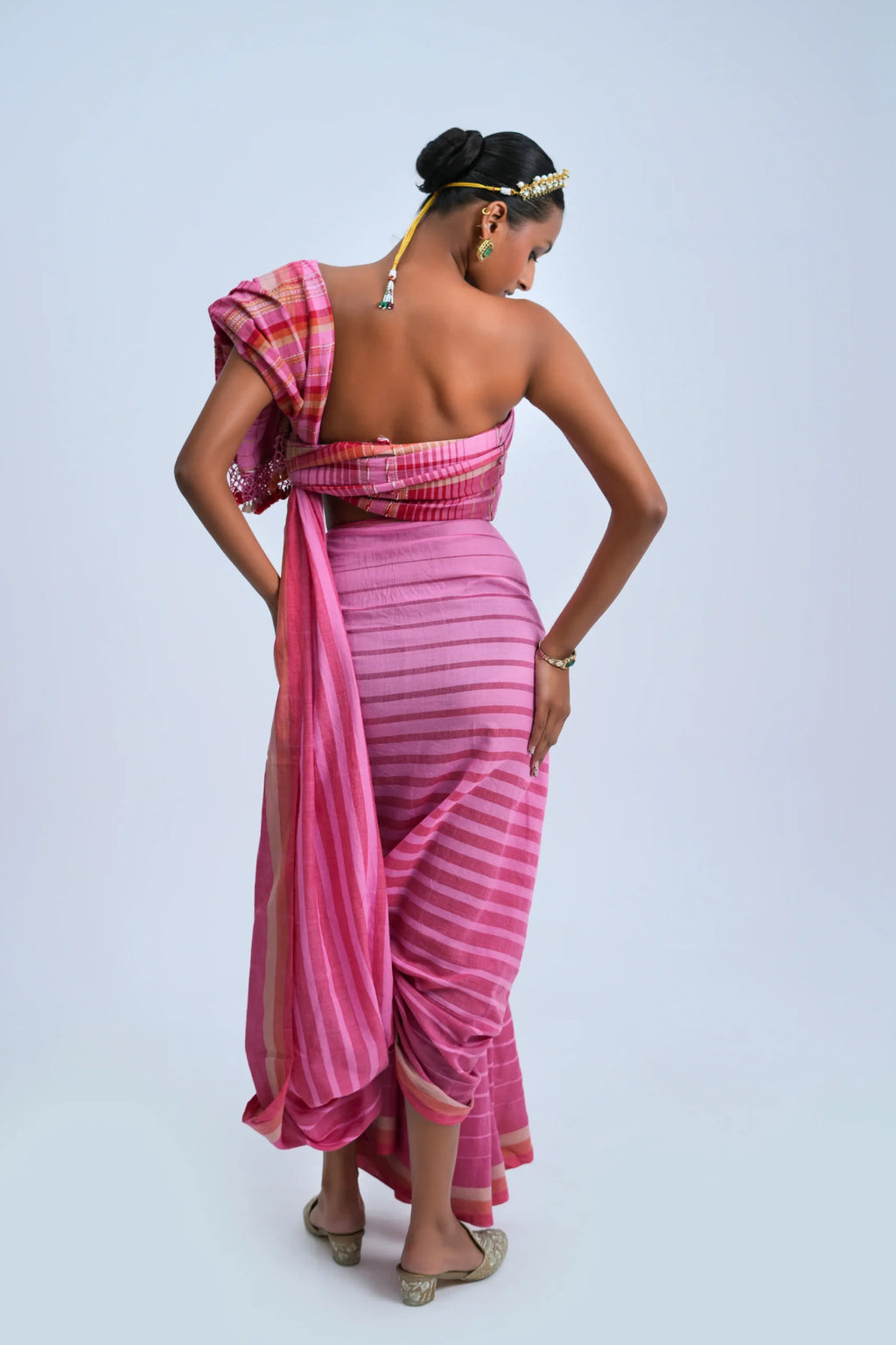 Rear full-length view of a model displaying the detailed check pallu composition and clean border alignment
