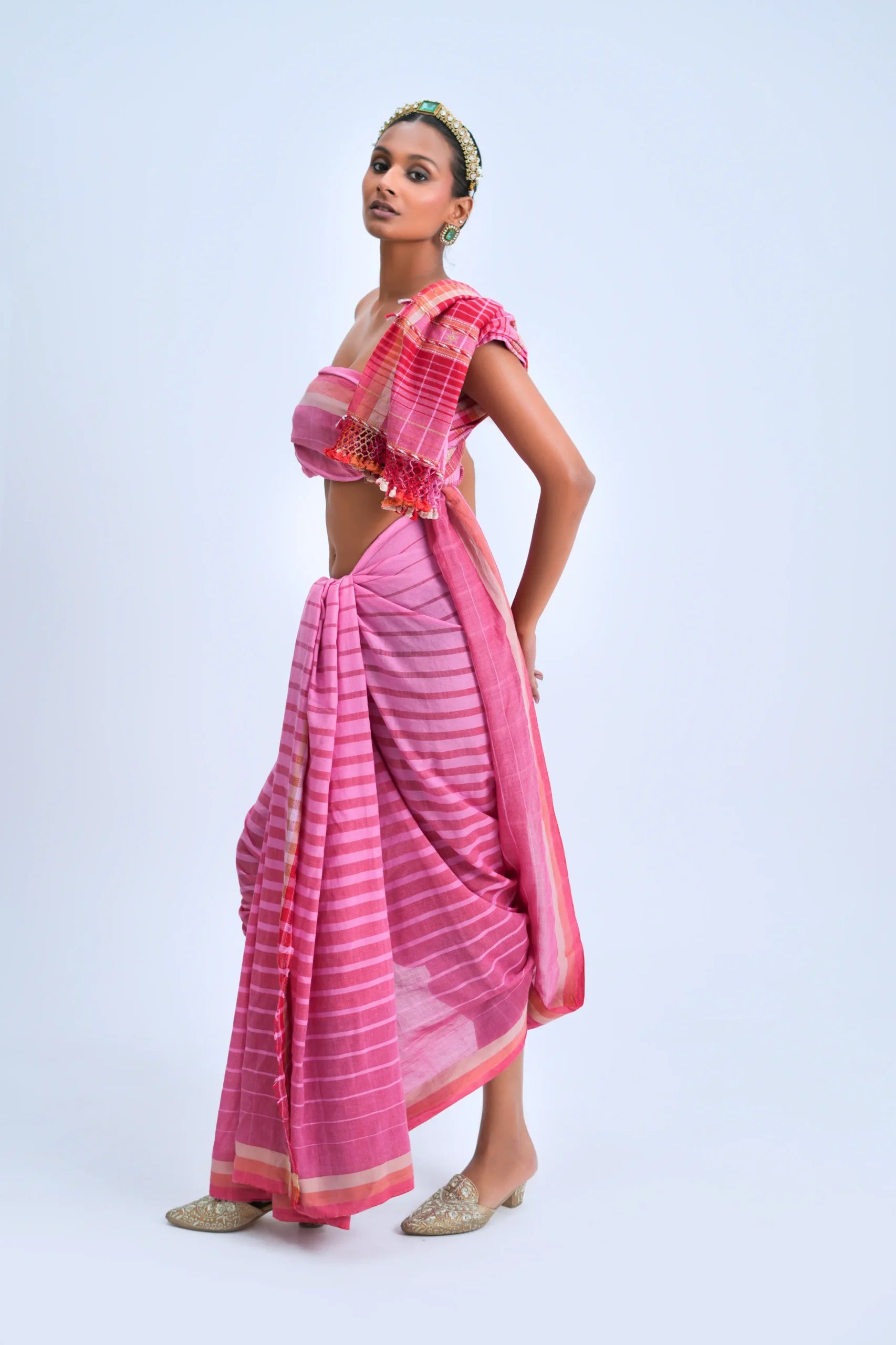Standing front view of a model showcasing the fluid drape and graduating pink ombre tones of the Bhujodi saree