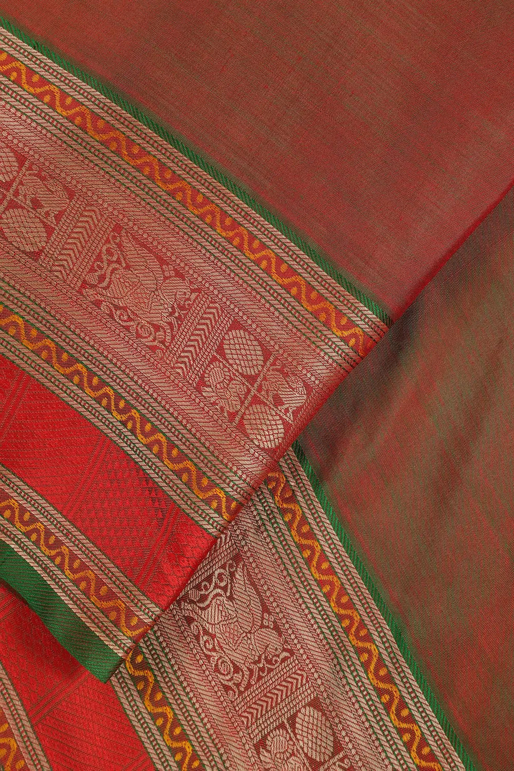 Close-up view of the striking red and green border framing the pure silk pink body