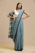 Polka Blues light indigo blue and black hand-block Bagru cotton saree displayed by a standing model