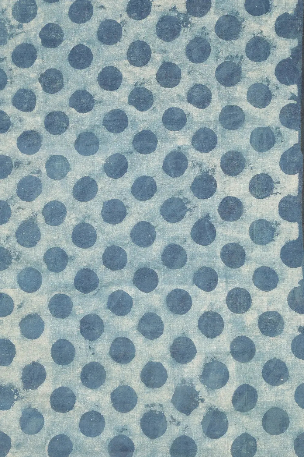 Close-up view of the light indigo blue cotton base highlighting the bold hand-block printed polka dots and thin black border
