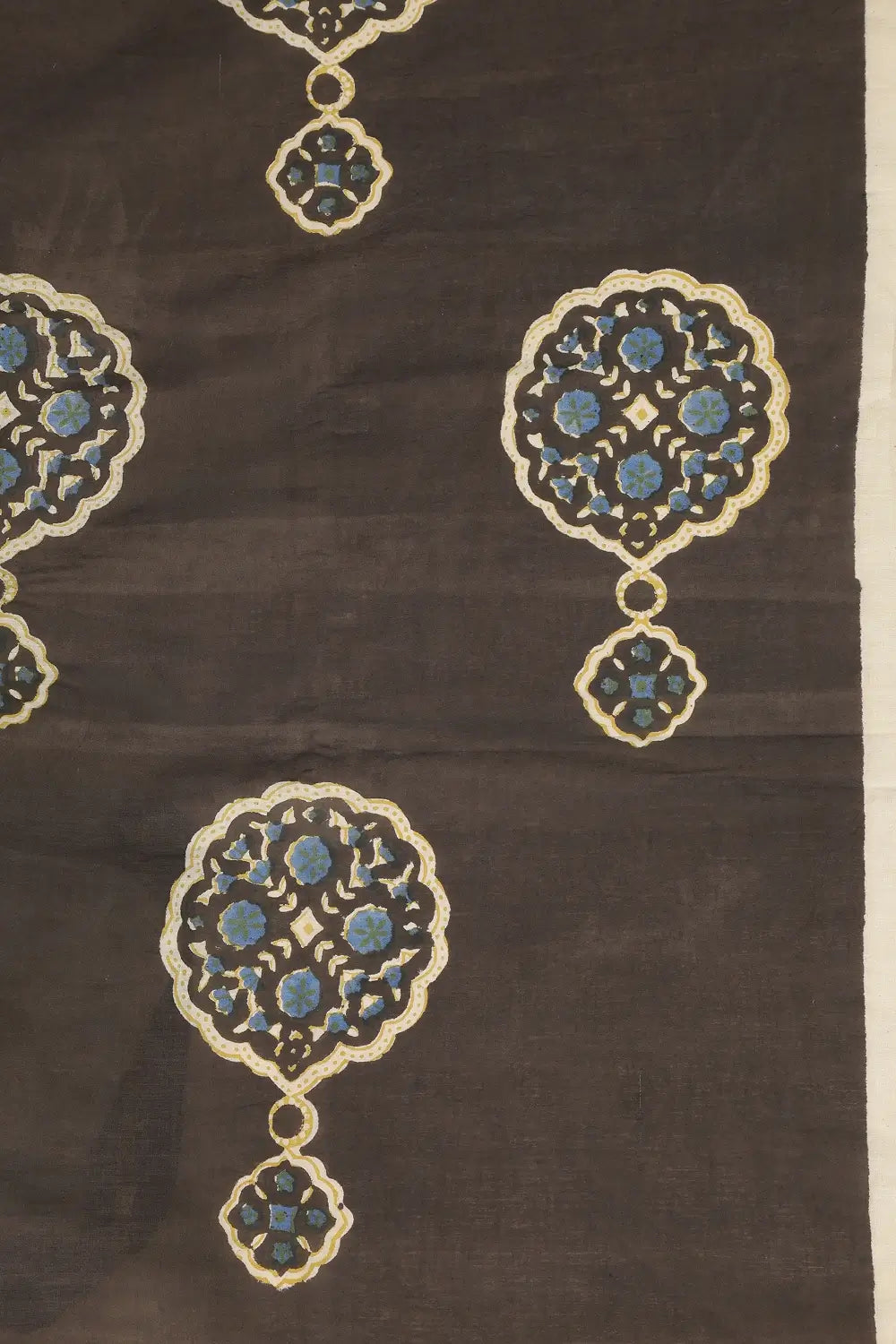 Close-up view of the black cotton saree highlighting the detailed red and blue boota motifs created via Bagru printing
