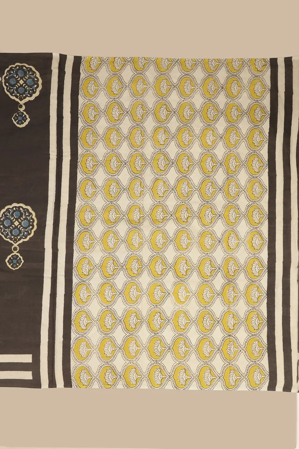 Flat lay detail view showcasing the contrasting beige pallu with yellow jaali design and black stripe borders