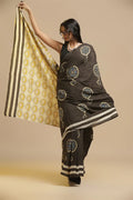 Rich black handblock print cotton saree featuring traditional Bagru boota motifs and striped pallu displayed by a model