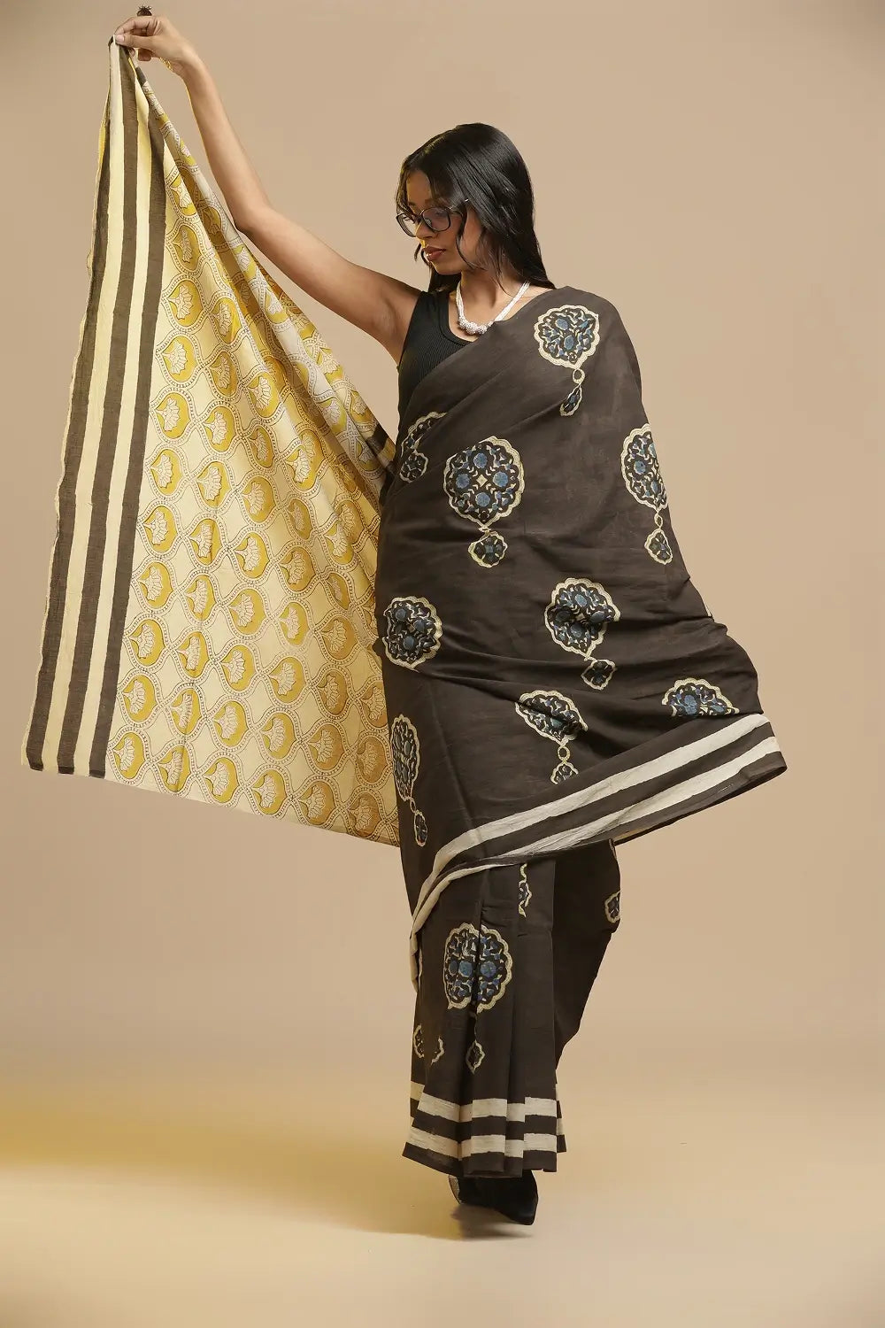 Rich black handblock print cotton saree featuring traditional Bagru boota motifs and striped pallu displayed by a model