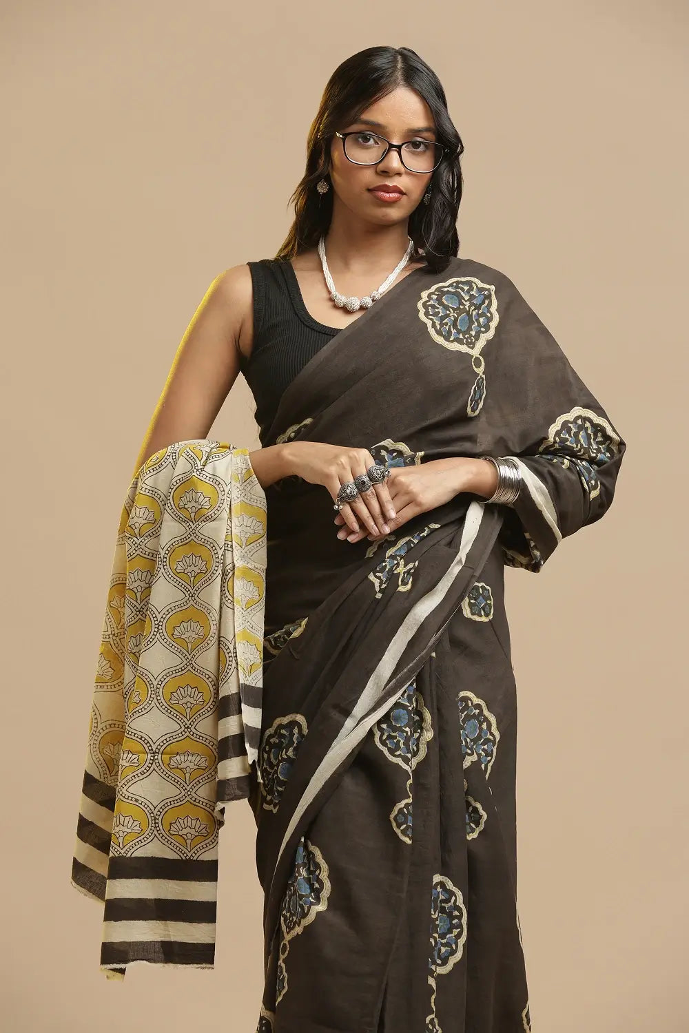 Model posing in the black Bagru handblock print cotton saree against a neutral studio backdrop
