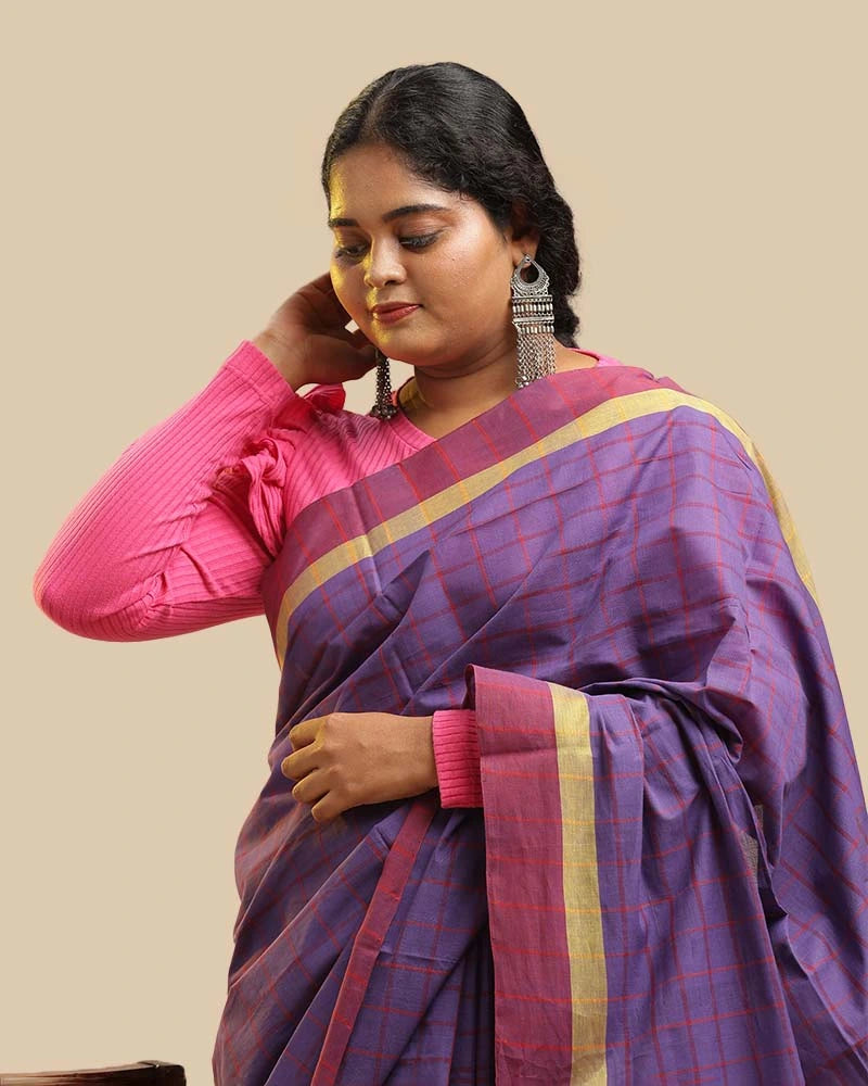 Close-up upper body view showcasing the royal purple checked weave, zari border, and pink blouse pairing of the Kasaragod saree