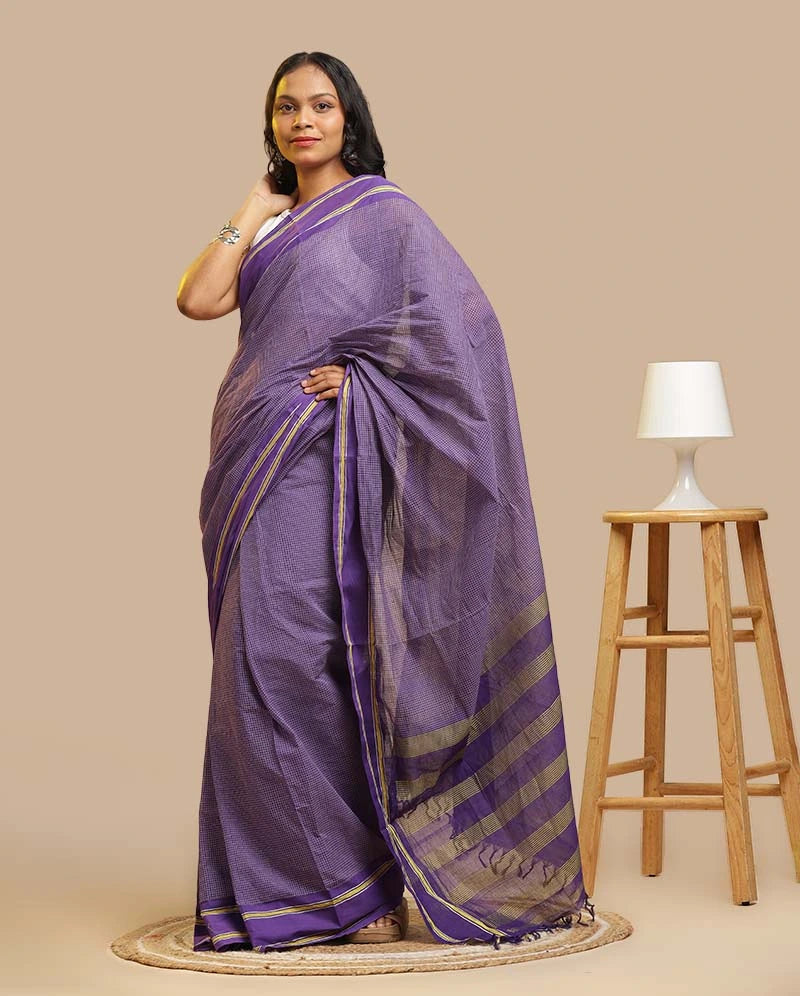 Model posing in a Royal Violet GI-tagged Udupi cotton saree on traditional Malabar frame loom background