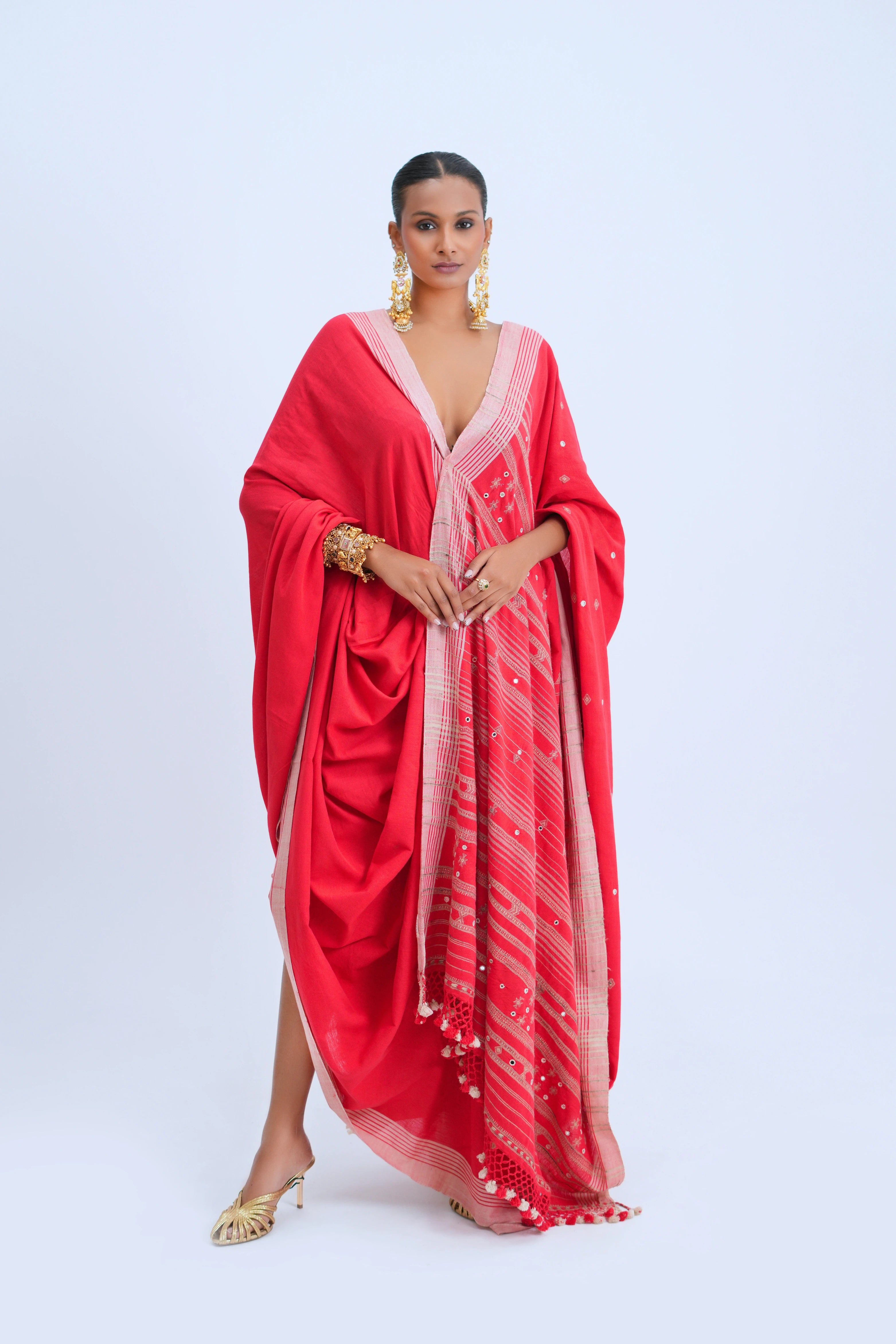 Full-length front view of a model wearing the bold scarlet red organic Kala cotton Bhujodi saree featuring blush-pink borders and a golden stripe pallu
