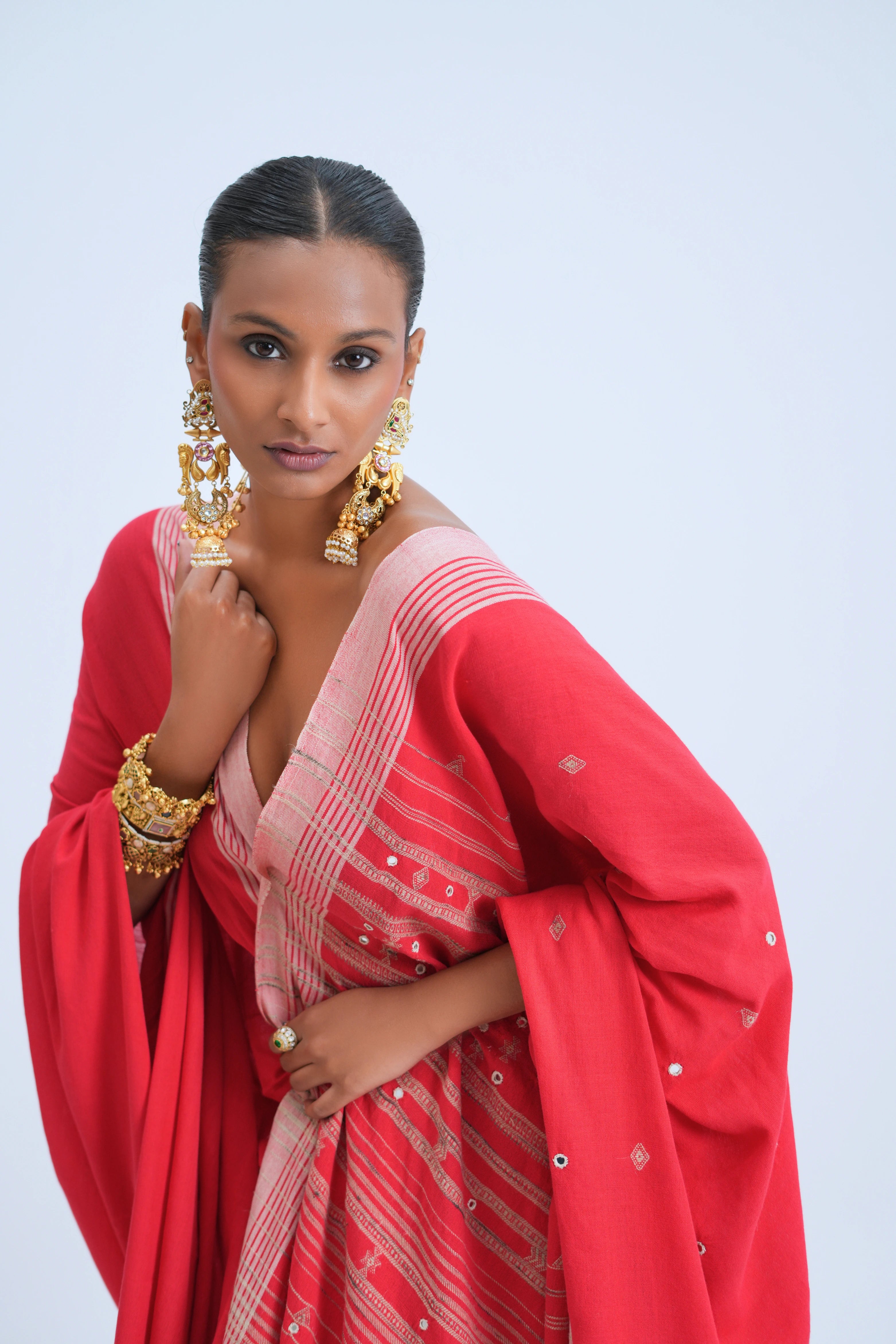 Close-up of the upper body drape showcasing the golden diamond buti motifs, mirror embellishments, and refined blush-pink border