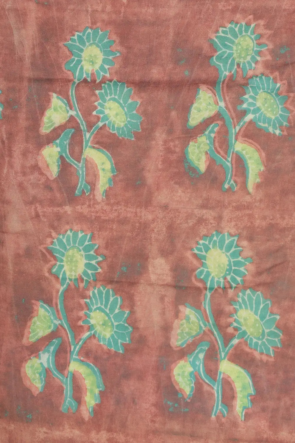 Close-up view of the warm rust brown cotton base highlighting the scattered soft teal-green floral motifs