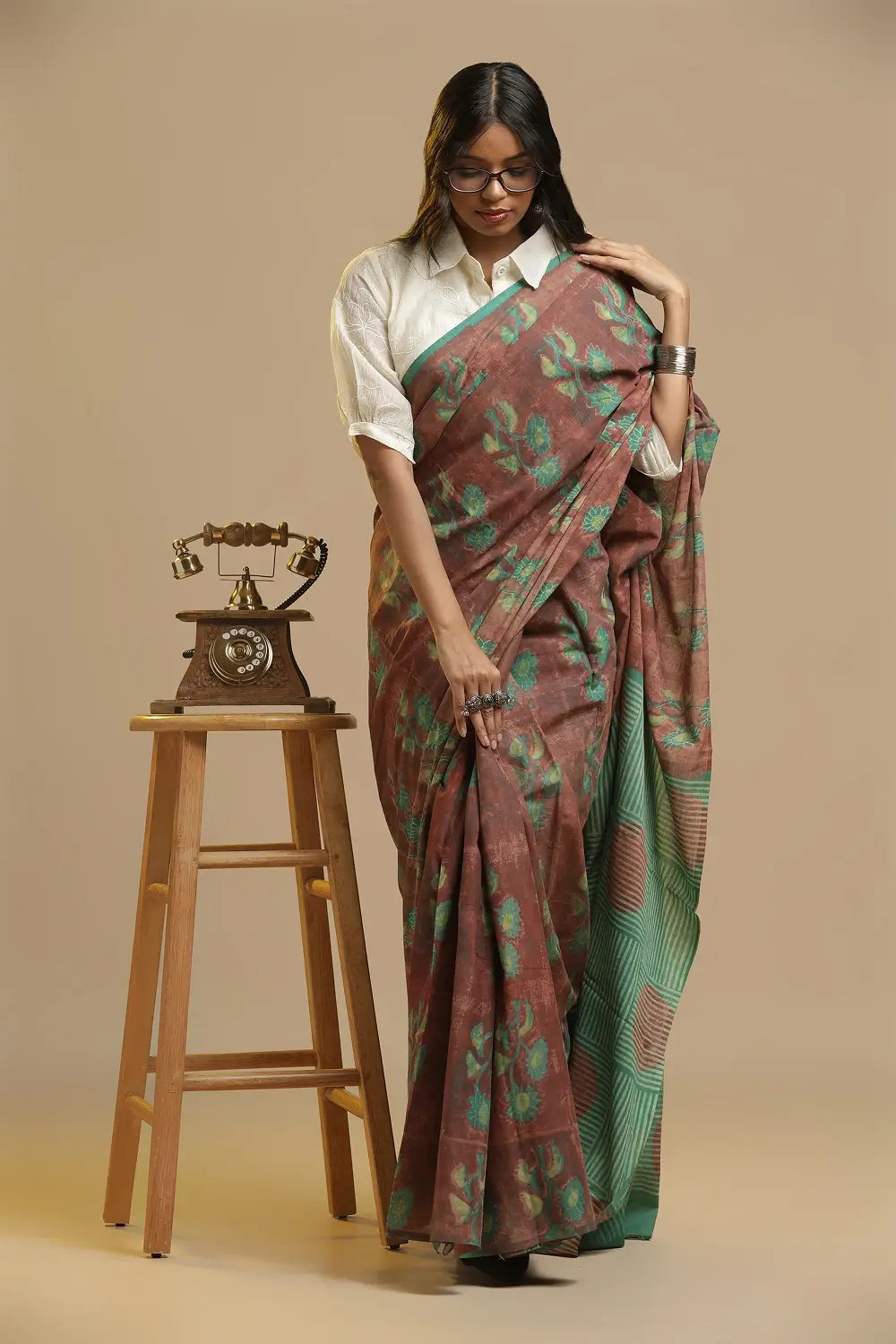 Full length view of the brown and teal green Bagru handblock print cotton saree showing the traditional drape