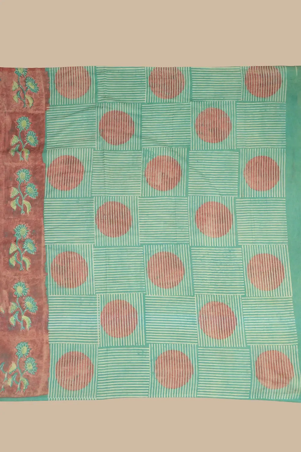 Detail view of the refreshing green contrasting pallu featuring fine linear stripes and oversized circular polka motifs