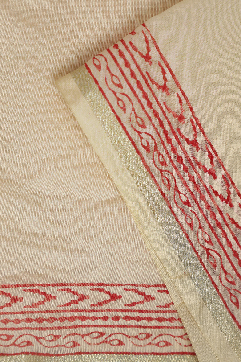 Close-up view of the folded Chanderi cotton-silk fabric highlighting the woven border and detailed handblock printed red motifs