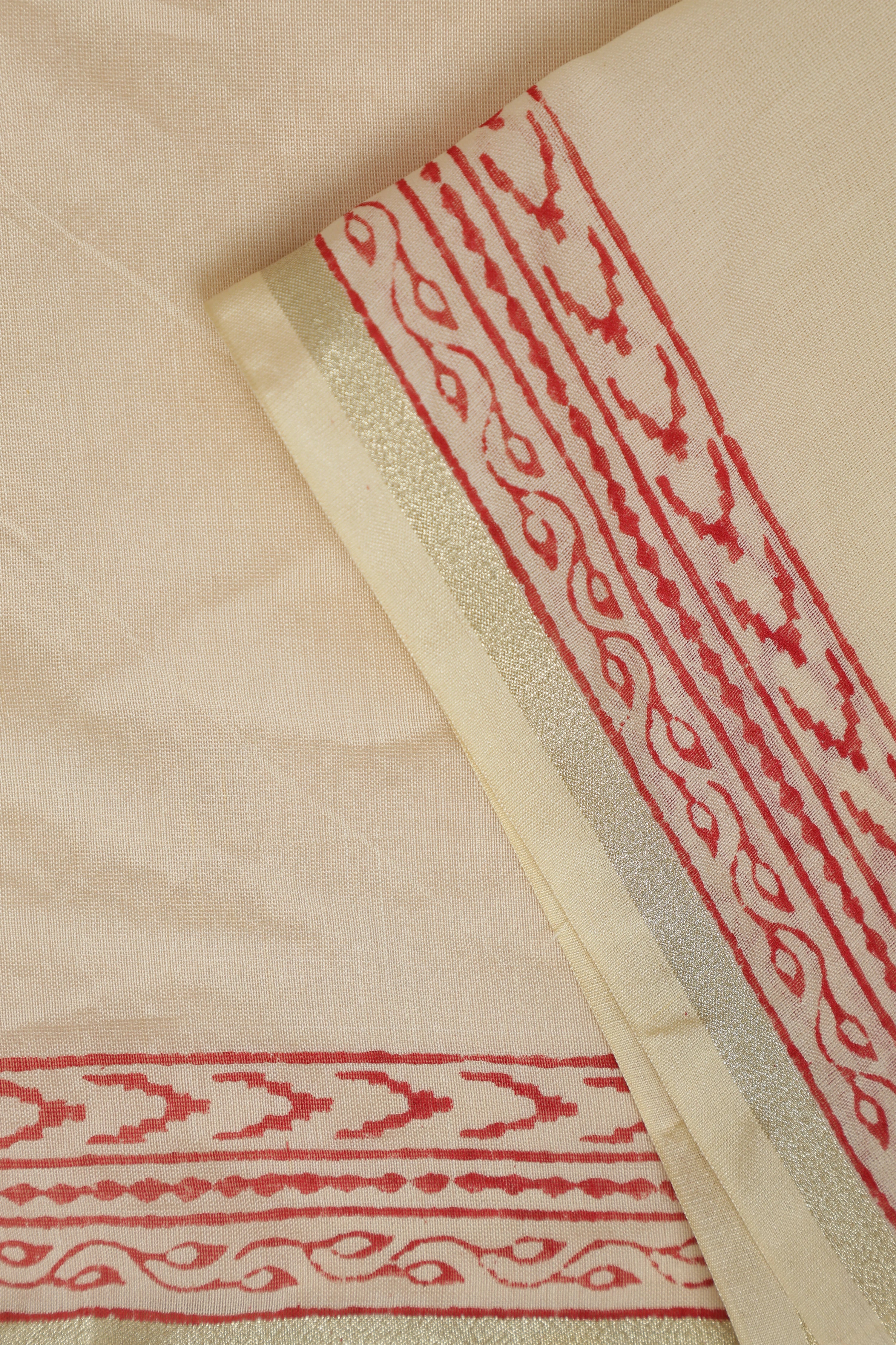 Close-up view of the folded Chanderi cotton-silk fabric highlighting the woven border and detailed handblock printed red motifs