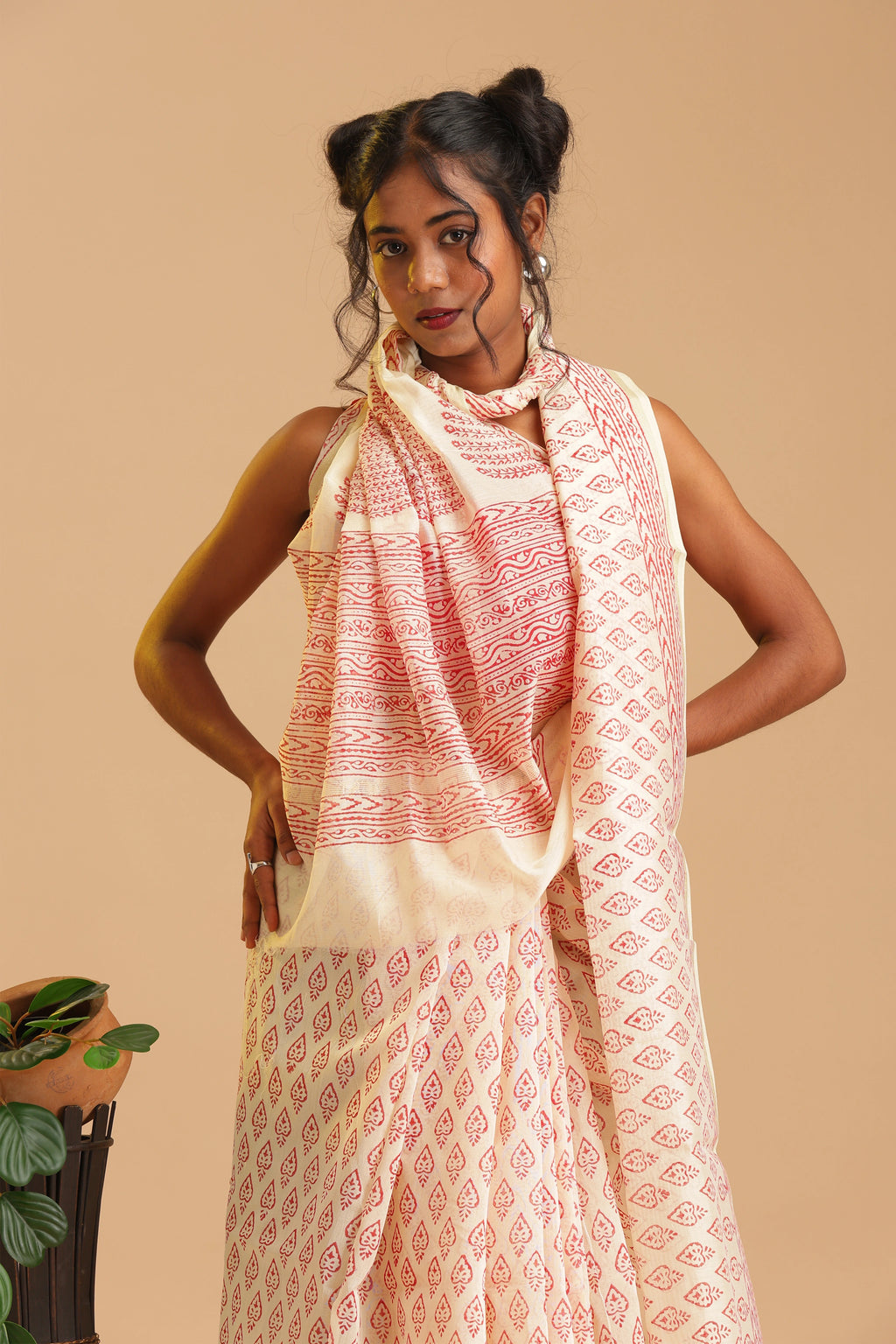 Standing studio side angle view highlighting the lightweight fabric and traditional crimson pattern work of the Chanderi saree