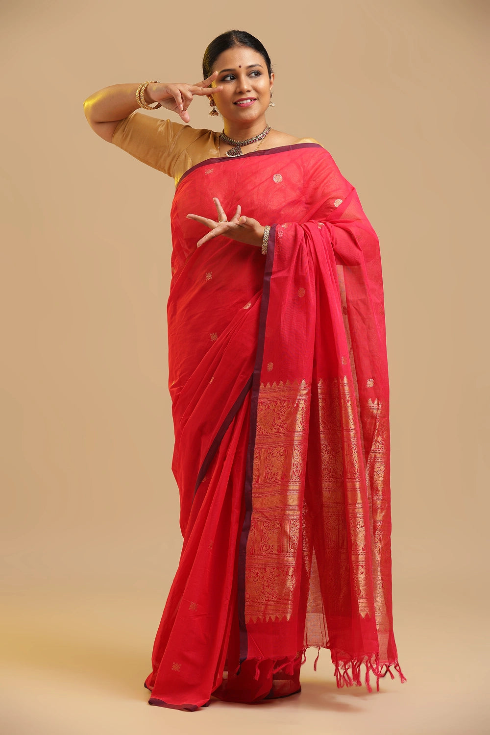 Six Motif Rich Pallu soft pink Kanchipuram handloom cotton saree displayed by a model in a traditional dance pose