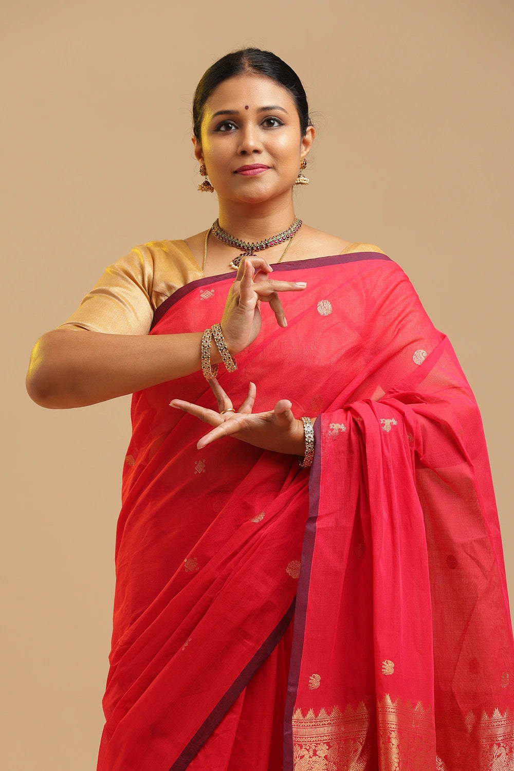 Model gracefully showcasing the soft pink Kanchipuram cotton saree against a neutral studio backdrop