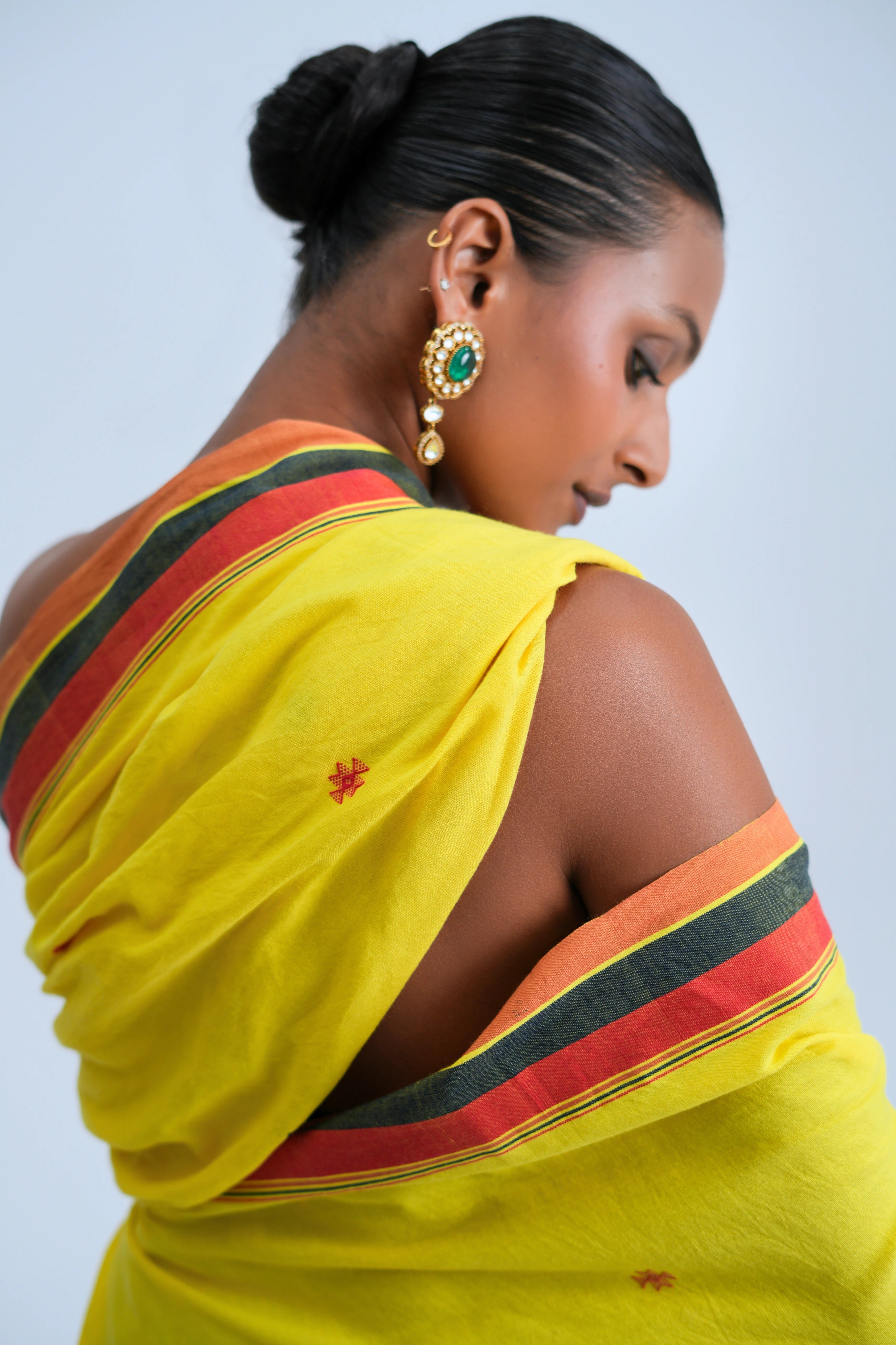 Close-up view of the detailed shoulder drape highlighting the rich texture, tribal motifs, and multicolour striped border