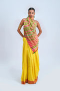 Full-length studio view of a model wearing a sunshine yellow pure handloom cotton Bhujodi saree featuring a burnt orange-rust border and vibrant multicolour stripe pallu