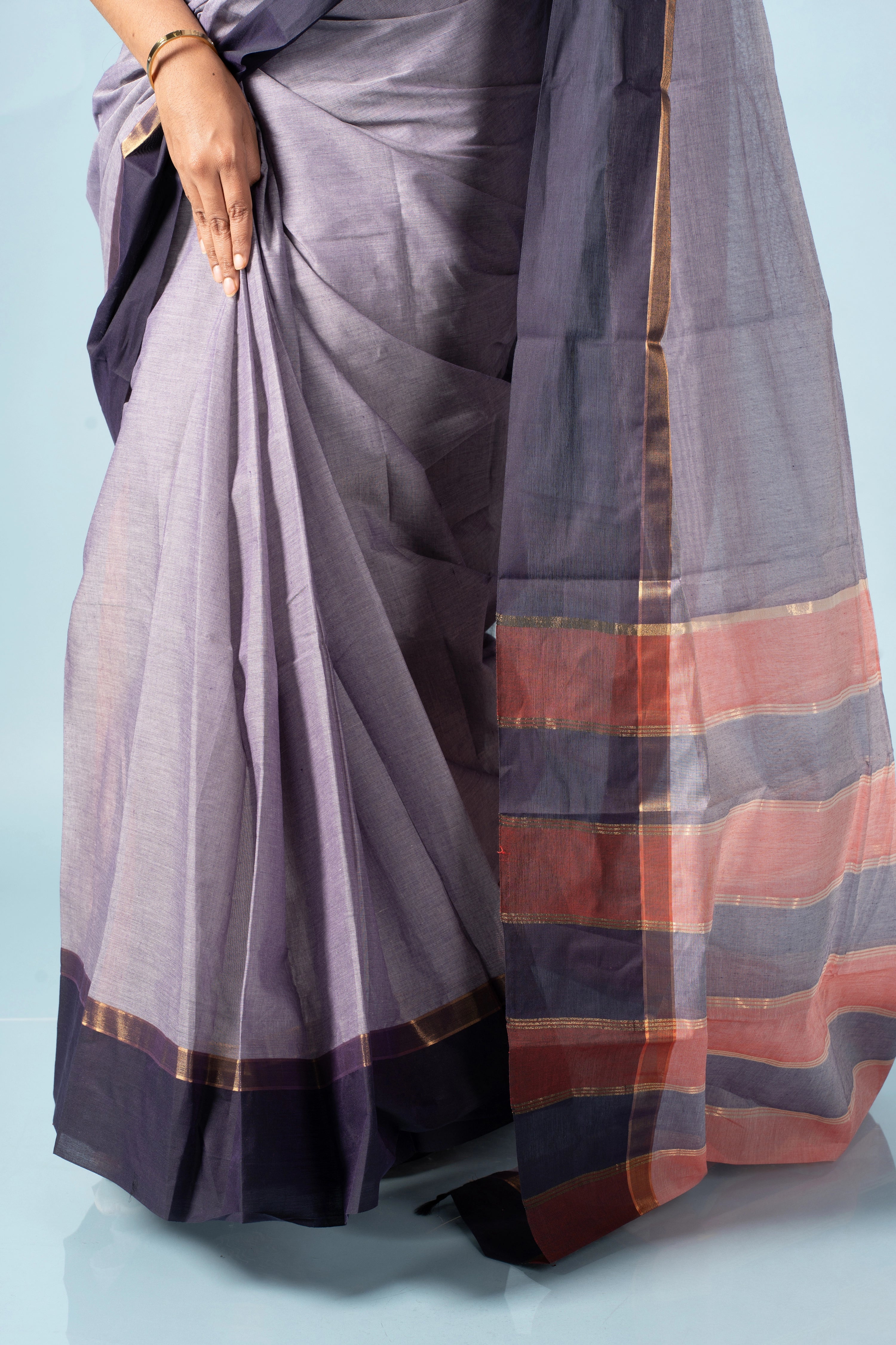 Close-up studio view highlighting the deep violet-navy borders, fine zari highlights, and breathable cotton weave