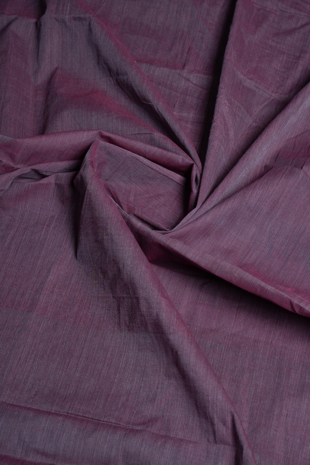 Macro close-up of the folded cotton fabric highlighting the lavender-grey tone and soft, organic handwoven texture
