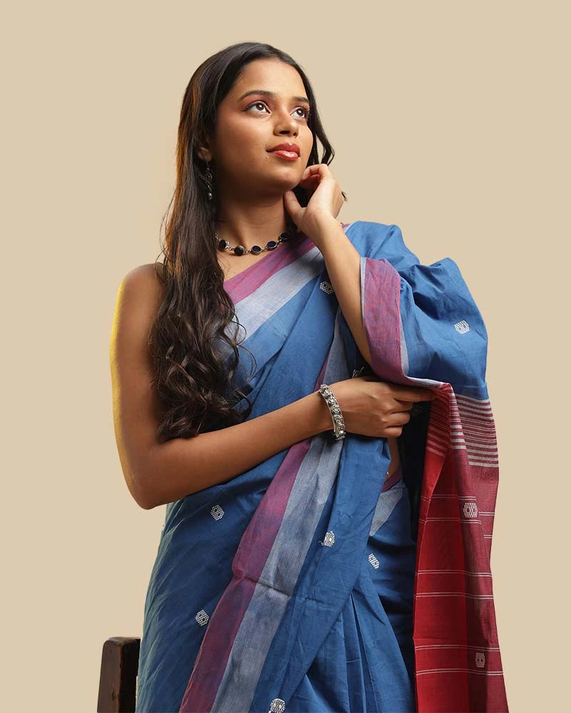 Close-up front view showcasing the calm blue weave, woven buti motifs, and blouse styling of the Kasaragod saree