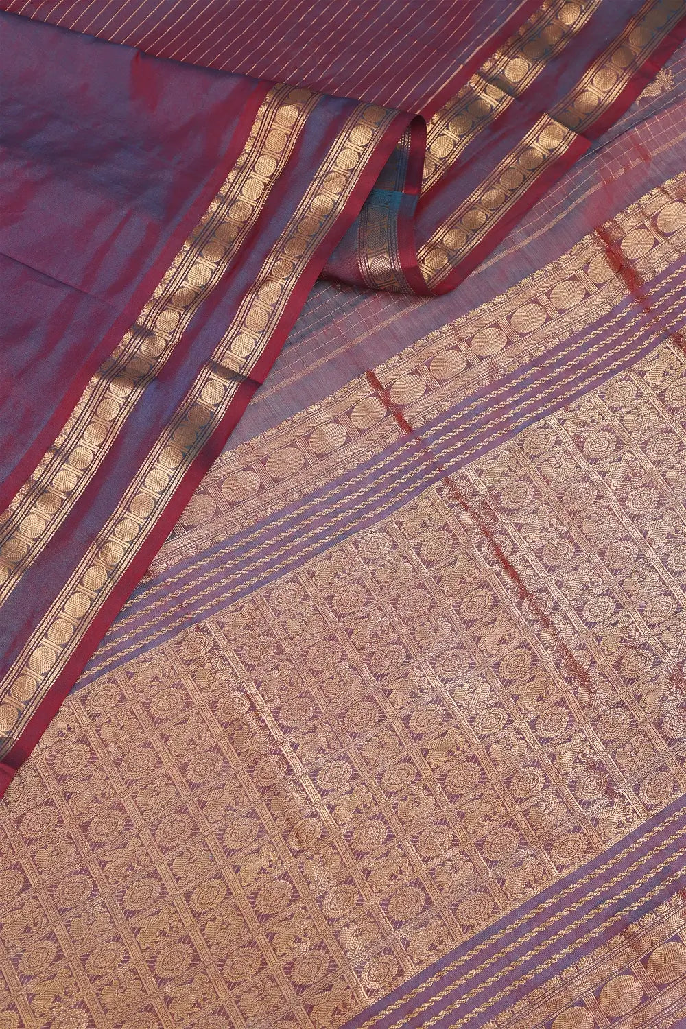 Detailed view of the intricate pallu weave folded neatly over the traditional golden border