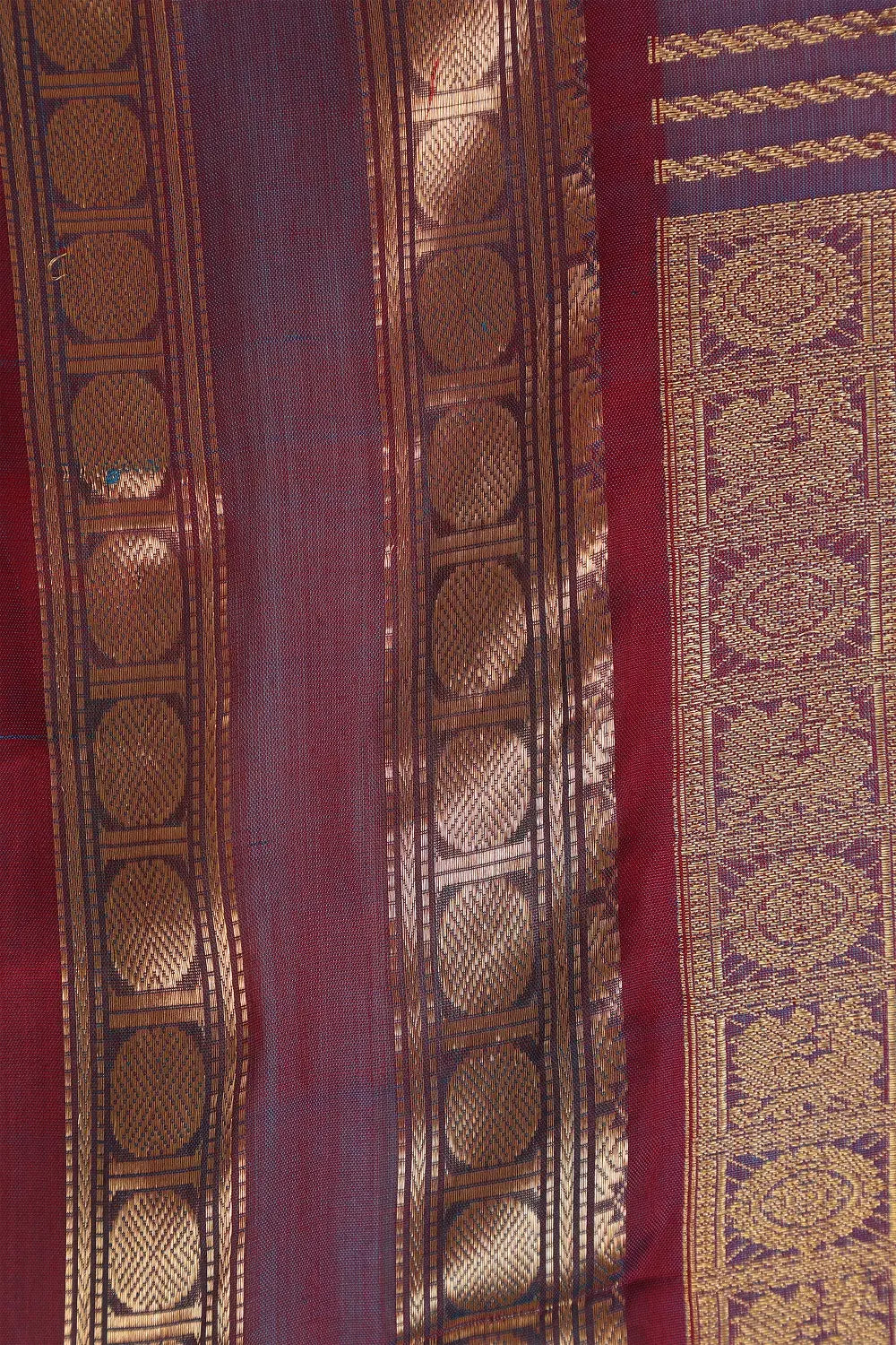 Detailed flat lay view of the rich traditional pallu featuring intricate zari work and woven fringes