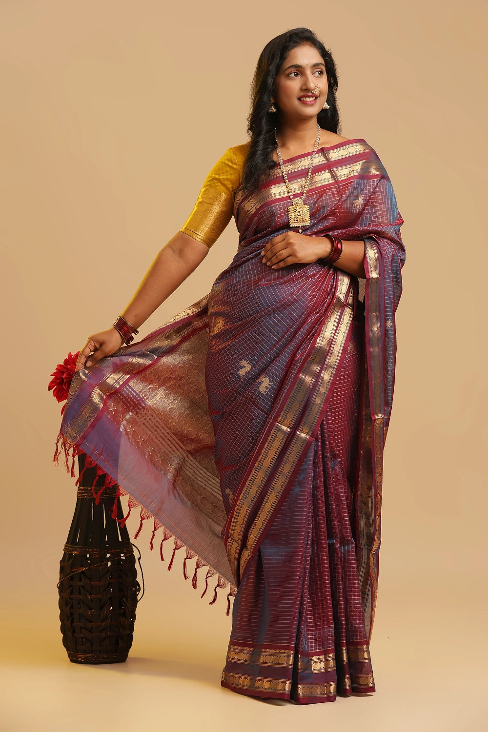Model gracefully posing in the two-tone lavender silk cotton saree against a neutral studio backdrop